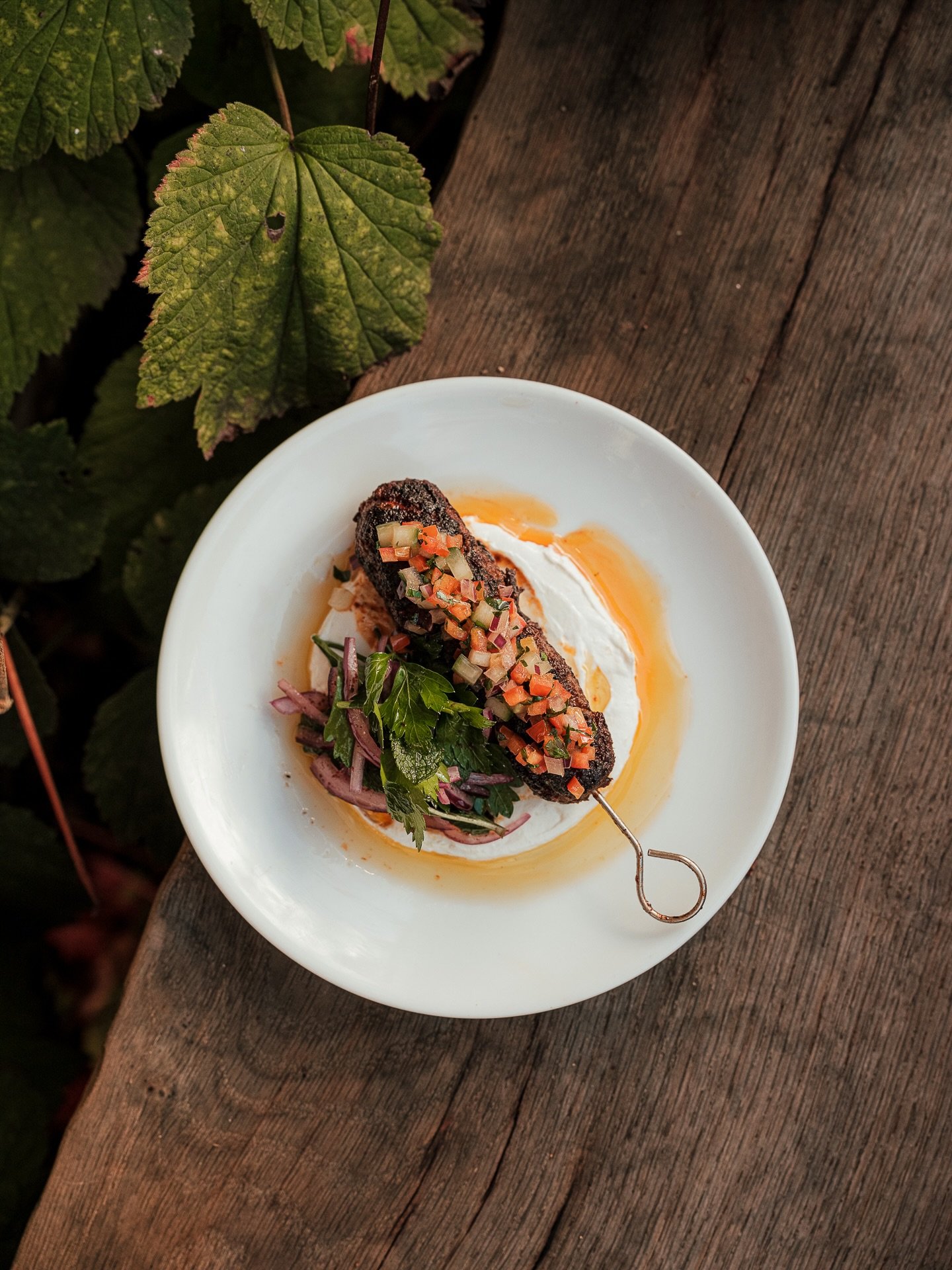Venison Merguez Skewer, on a bed of Labneh and topped with Ezme. Usually served as an appetiser on its own, a Tomato &amp; Red Pepper Ezme, originating from Turkey was the perfect topping to accompany the Venison. Fresh and full of flavour.