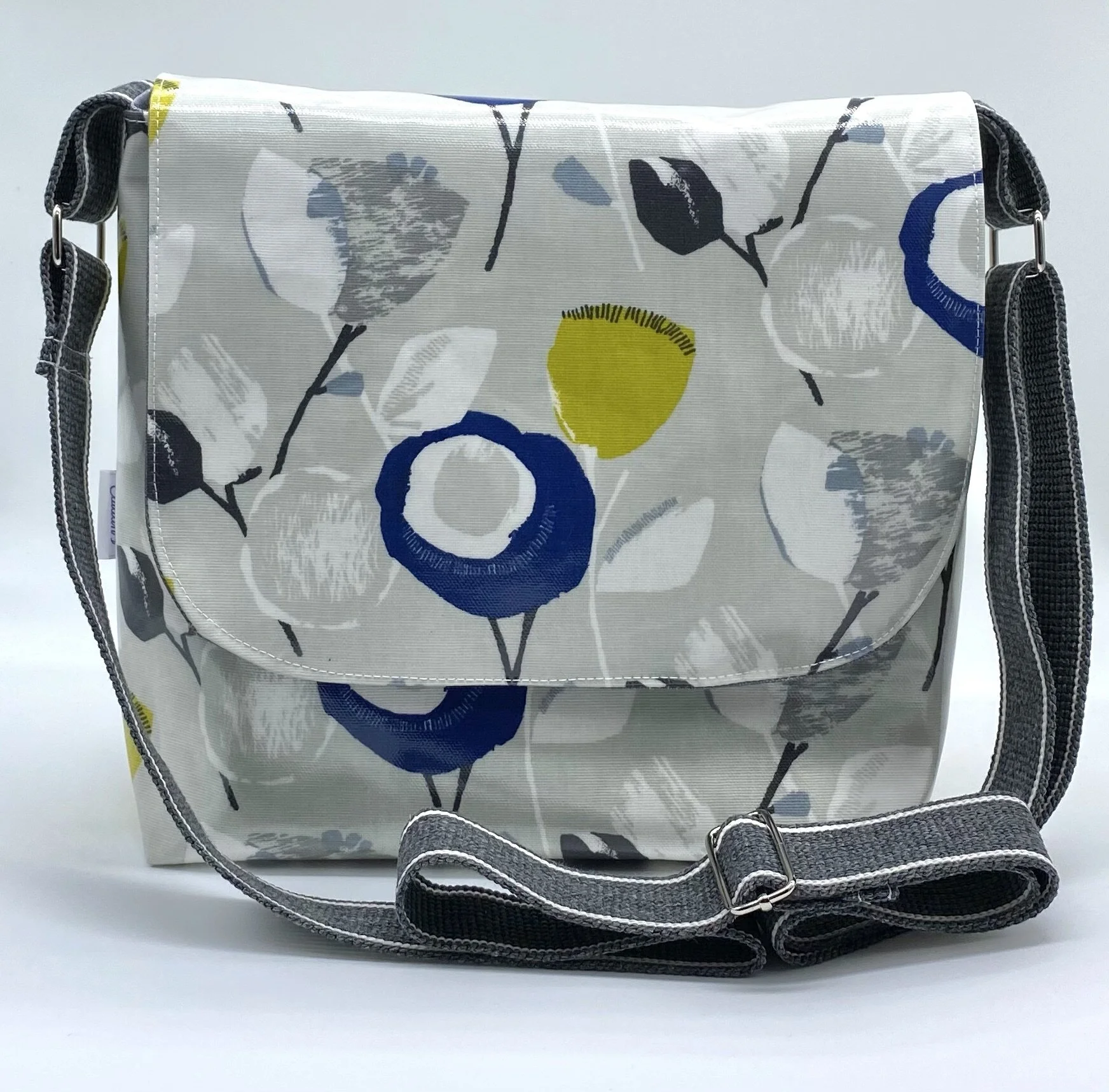 Grey floral oilcloth messenger bag