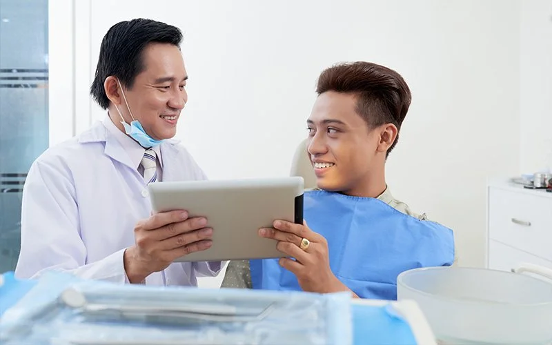 a dentist explaining tooth X rays to a patient