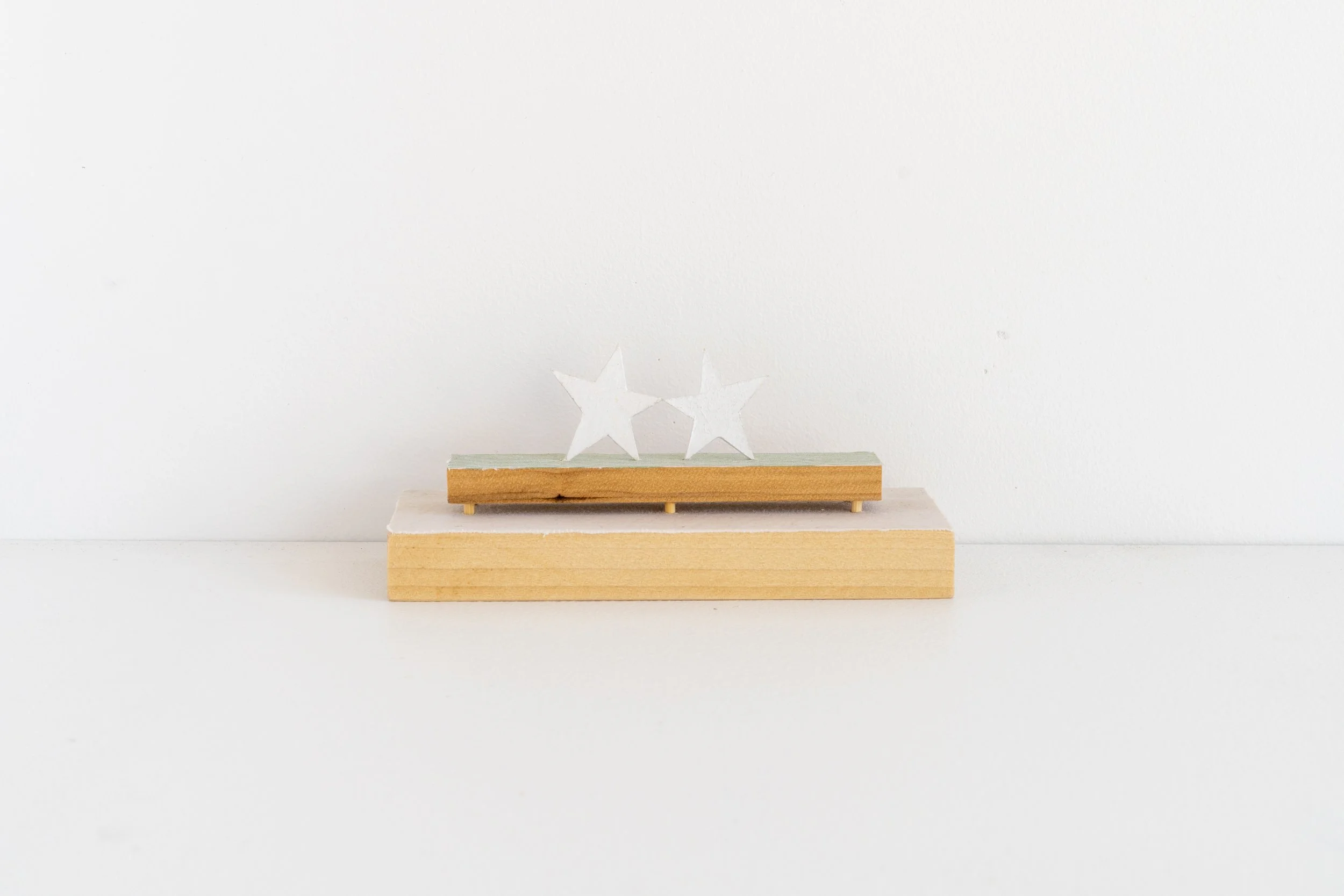 Eric Oglander, Clones, 2025, poplar, fabric from bed sheet, fabric from button down shirt, paper, acrylic paint, epoxy, bamboo skewers, 6 x 2 ½ x 2 ⅜ inches