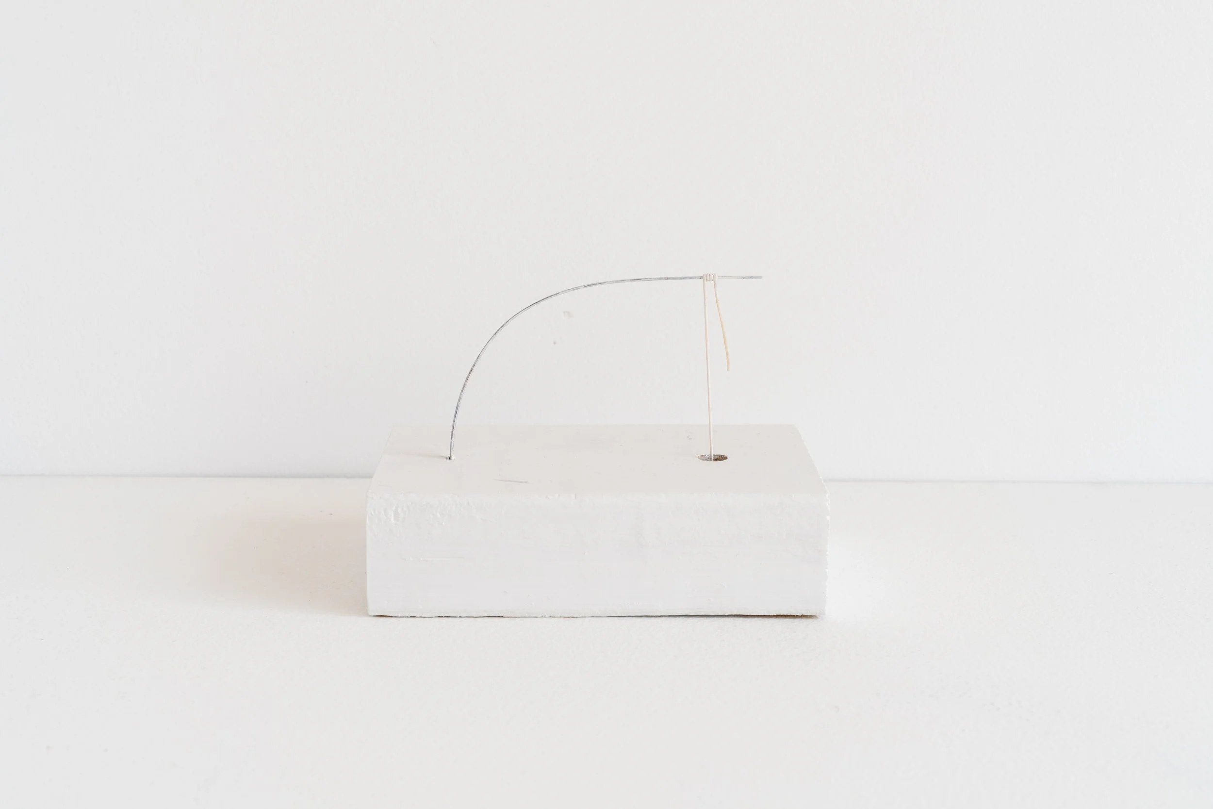 Eric Oglander, Hotdog down a crawdad hole, 2024 - 2025, pine, nylon string, street sweeper bristle, epoxy, India ink, enamel paint, 5 ⅜ x 4 ⅞ x 3 ½ inches