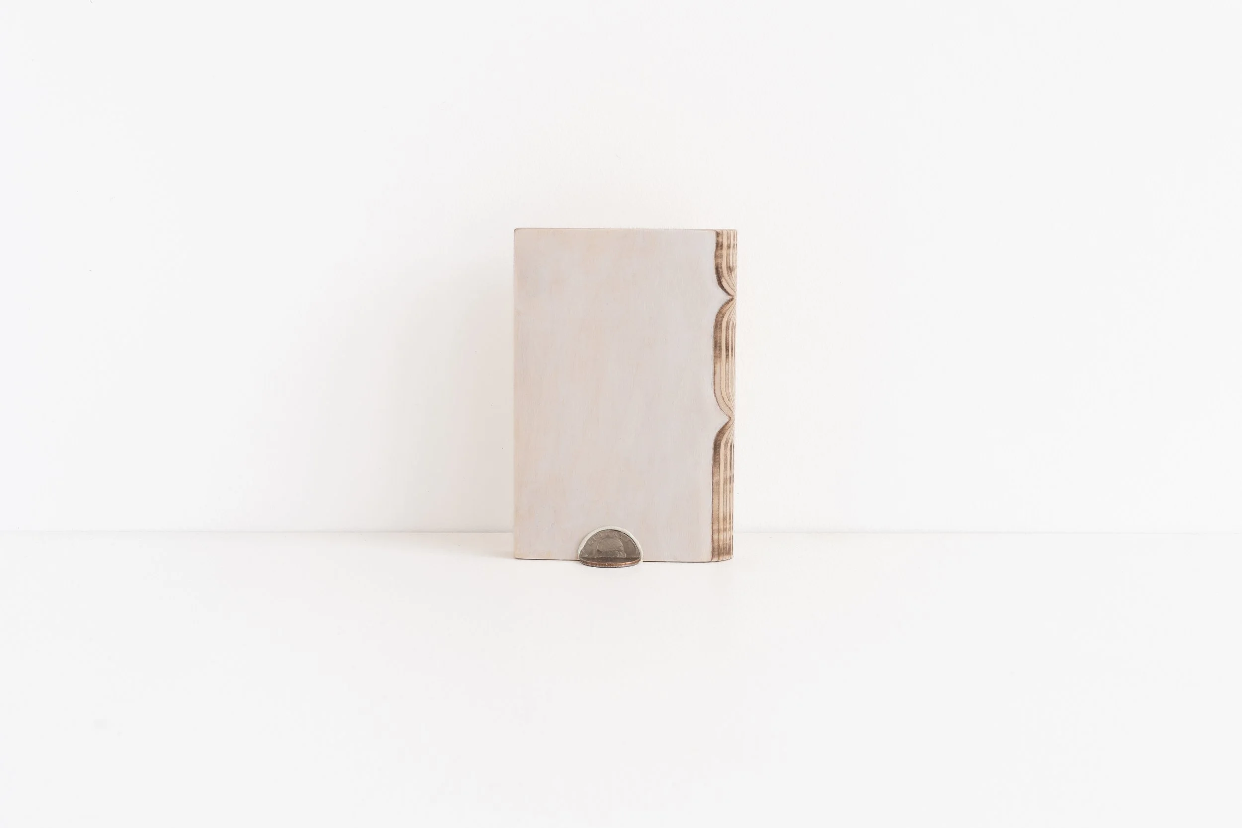 Eric Oglander, 1972, 2025, plywood, epoxy, quarter, acrylic paint, 3 ½ x 5 ¼ x ¾ inches