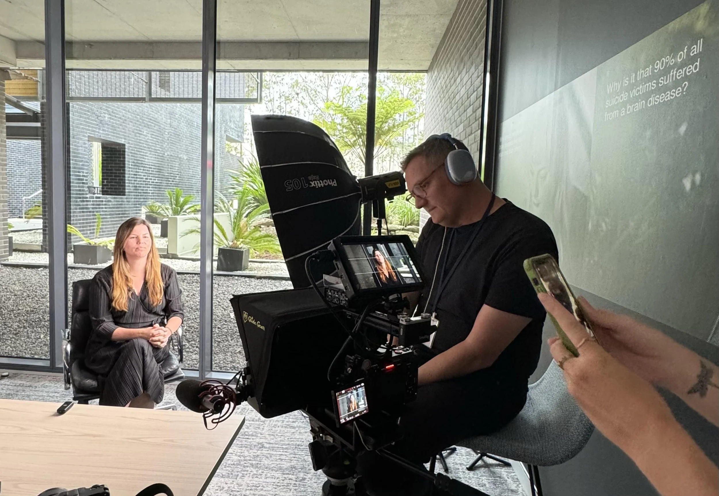a videgrapher records a corporate video interview in a Sydney office