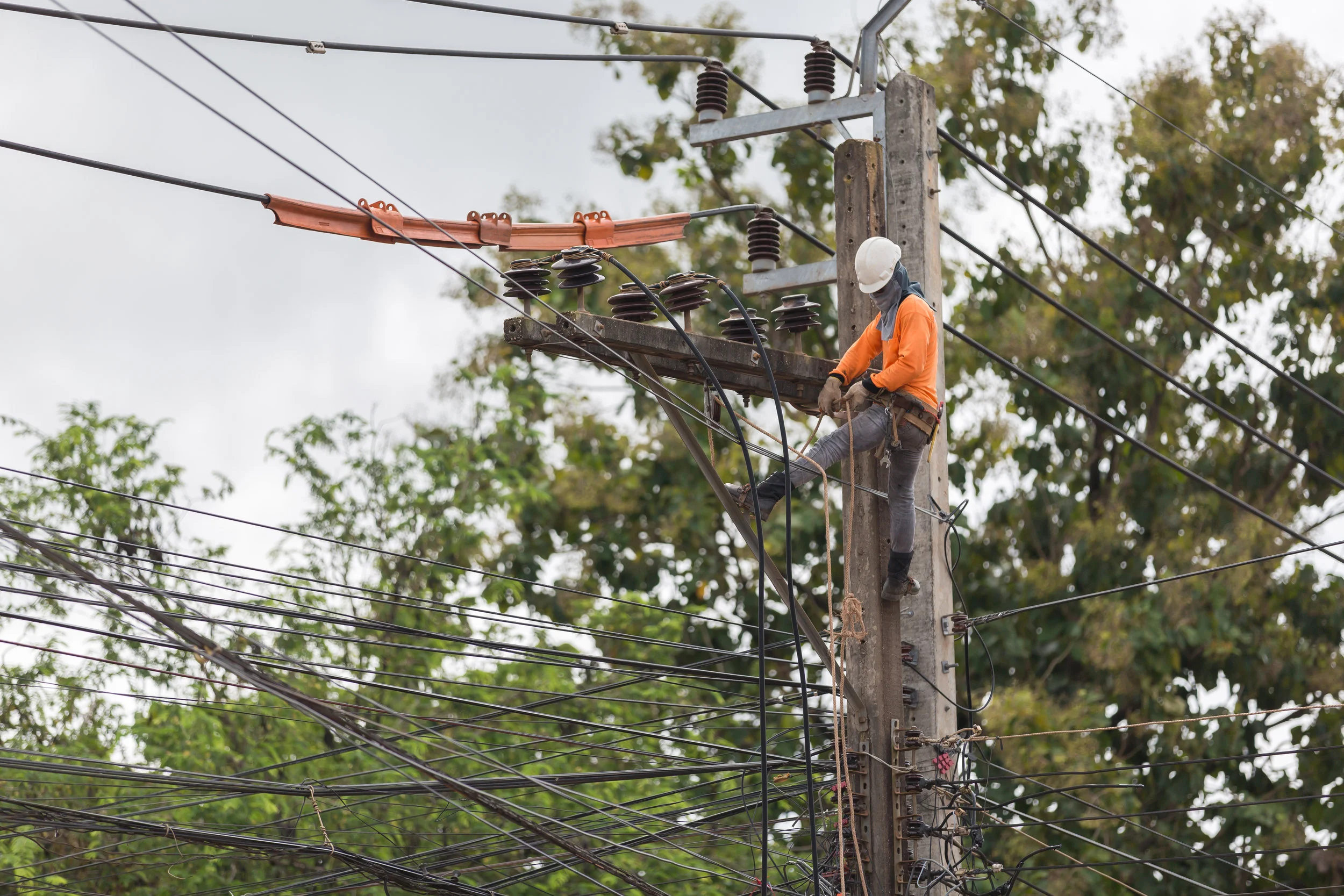 A lineman repairs electrical lines after a storm. Many homes across the USVI were without electricity for many months after hurricanes Irma and Maria in 2017.