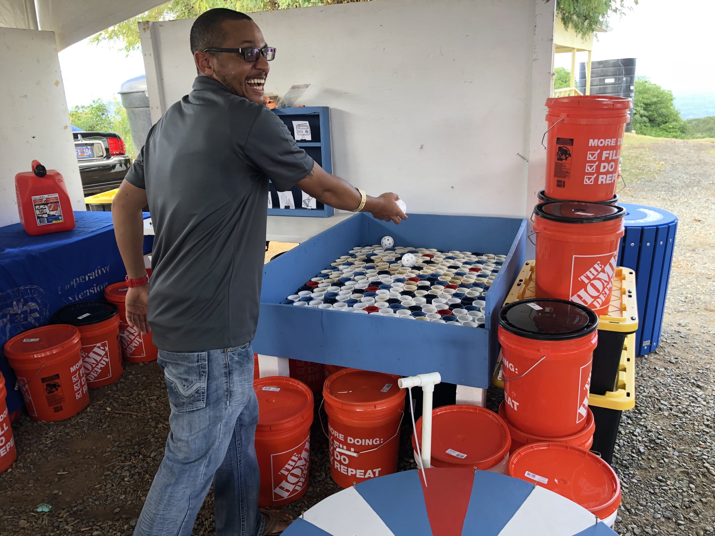  Howard Forbes, Jr. St. Thomas/St. John Coordinator for the Virgin Islands Marine Advisory Service demonstrates how to play the carnival-themed games created for the supply distribution CTP at the 2019 St. Thomas &amp; St. John Agricultural Fair. Pho