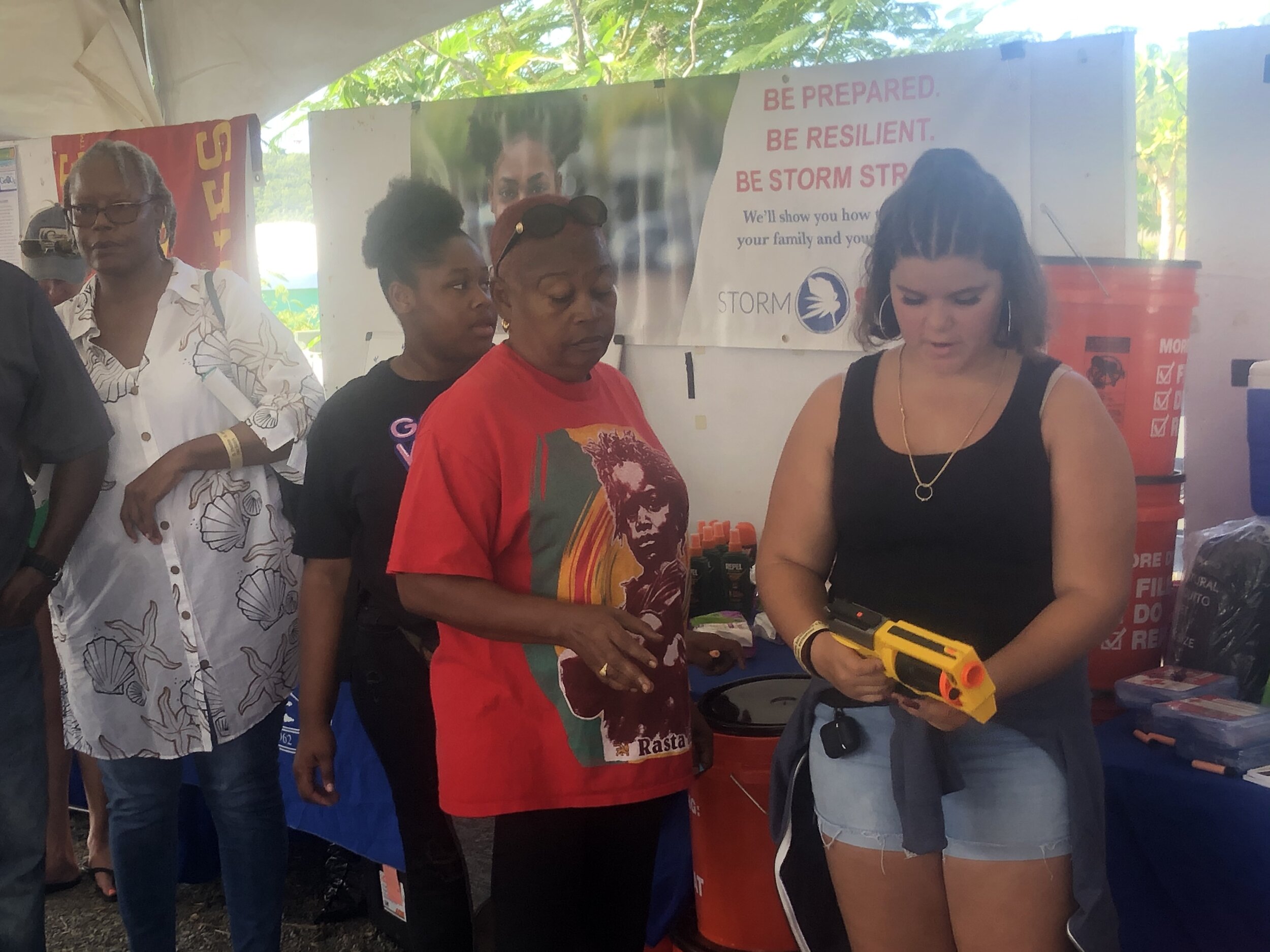  Amber LaPlace demonstrates how to play one of the three carnival games designed to distribute free hurricane supplies to community members at the 2019 St. Thomas &amp; St. John Agriculture Fair. Photo: KW Grimes. 