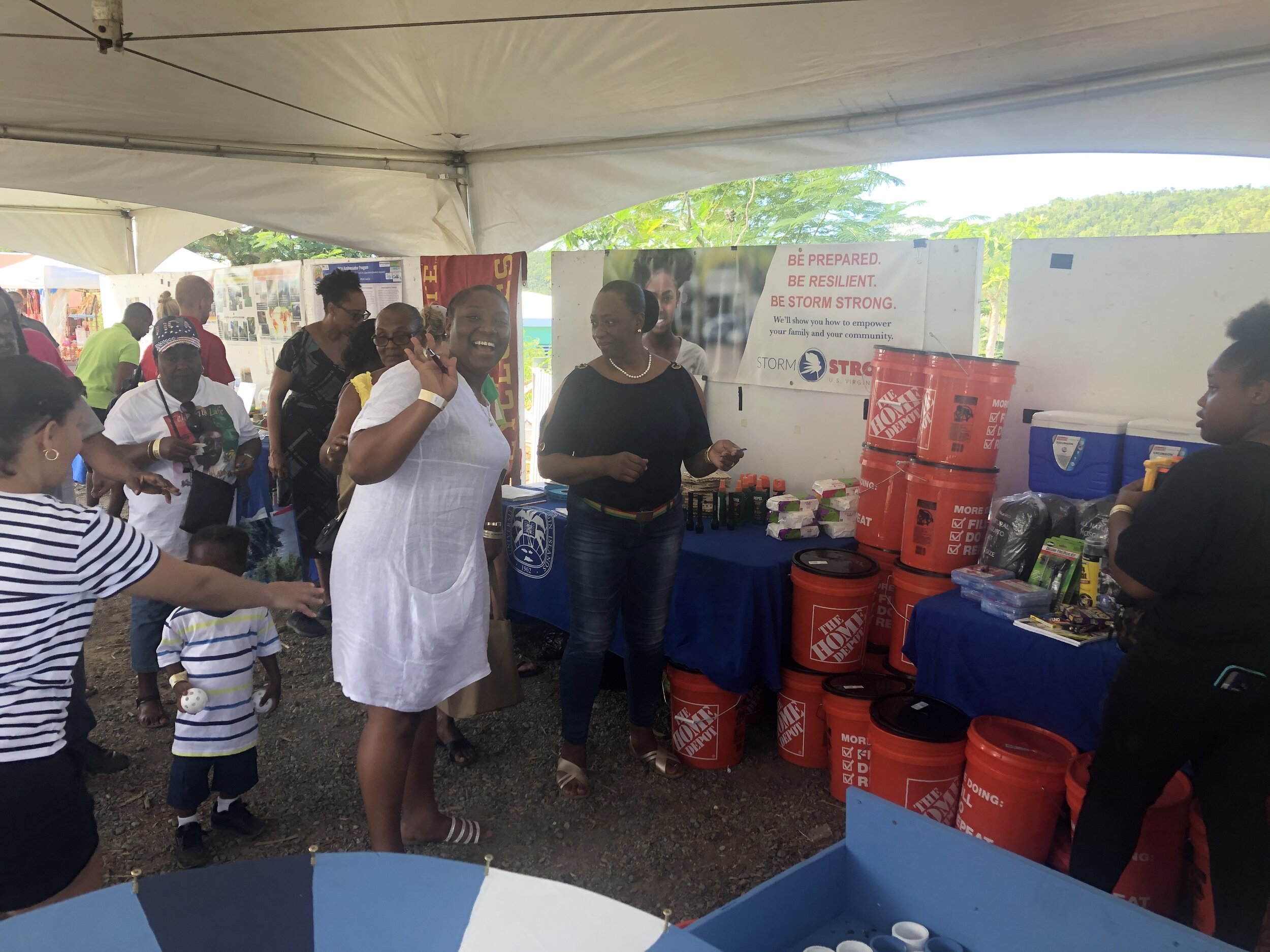  USVI Storm Strong Program participants Kaylin Wallen and Jessica LaPlace direct community members to play carnival games for the supply distribution CTP at the 2019 St. Thomas &amp; St. John Agricultural Fair. Photo: KW Grimes. 