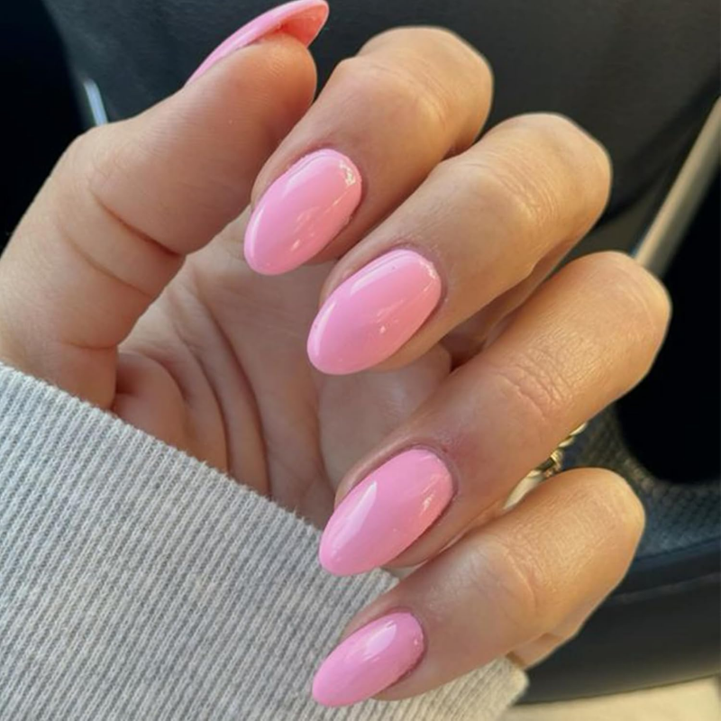 Bubblegum pink nails that make your skin look more tan and enhance a sun-kissed glow.