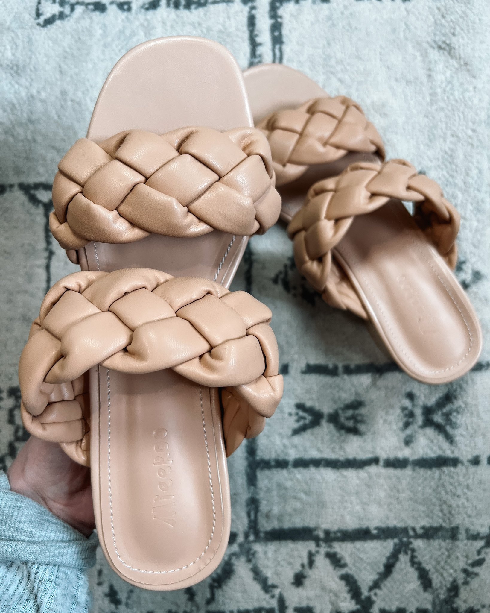 a pair of beige braided sandals