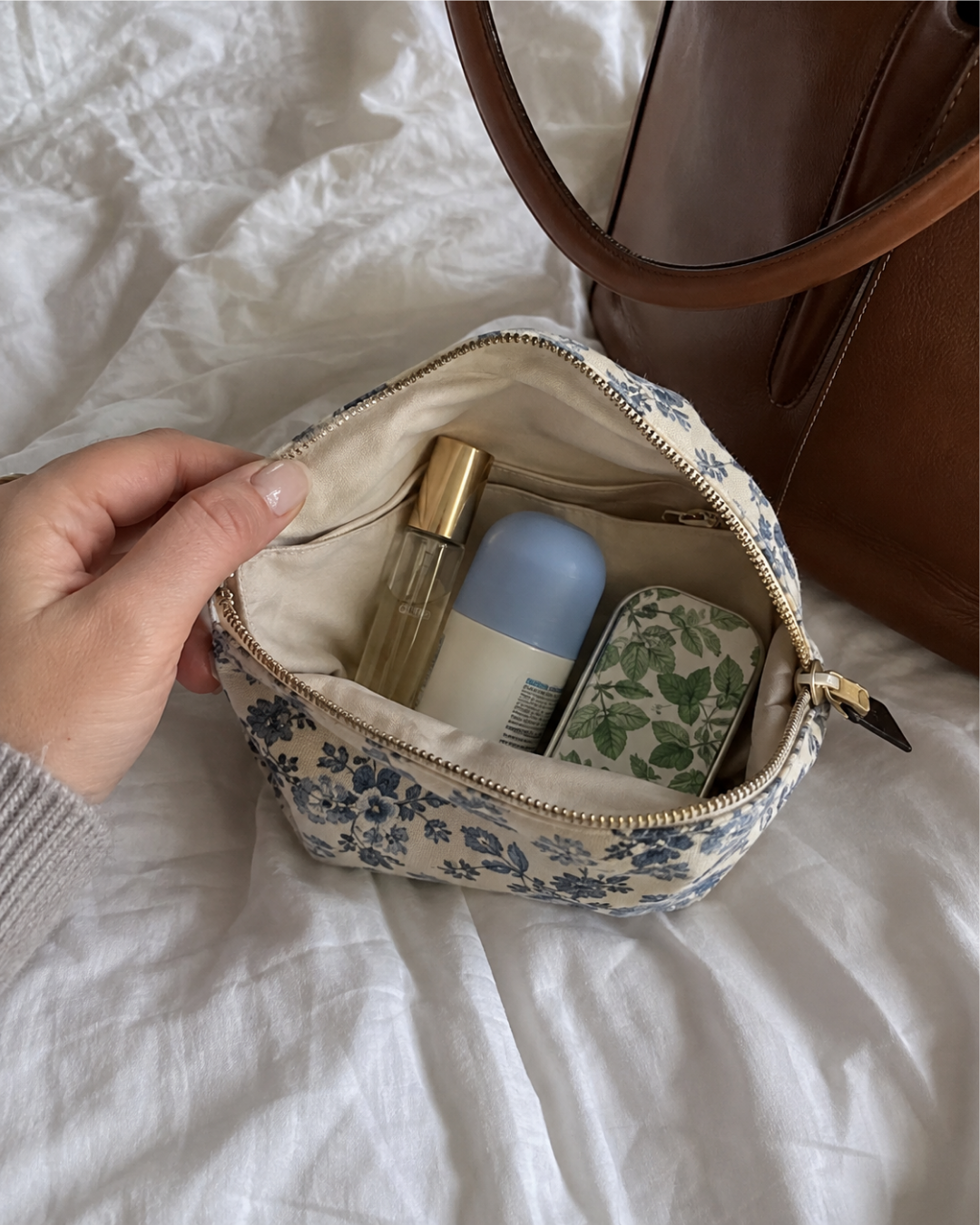 small pouch with mini lotion and fragrance inside