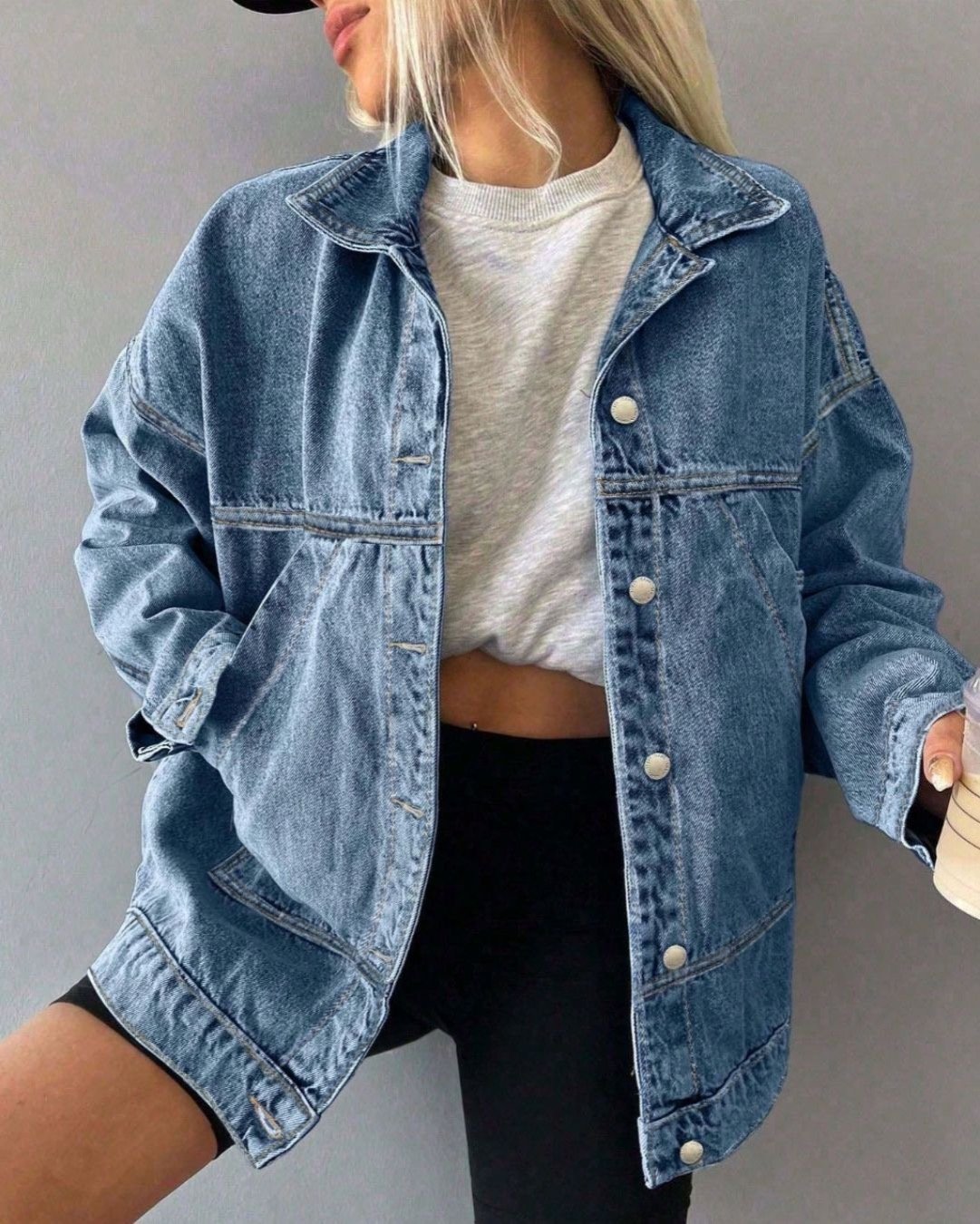 woman wearing a denim jacket and bike shorts outfit