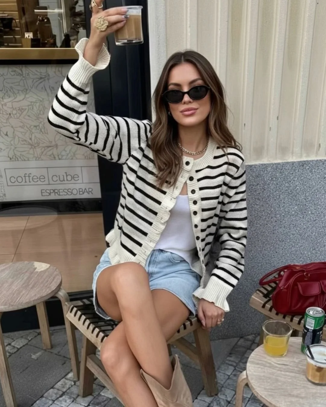 cool girl outfit with striped cardgan, denim shorts, and cowboy boots