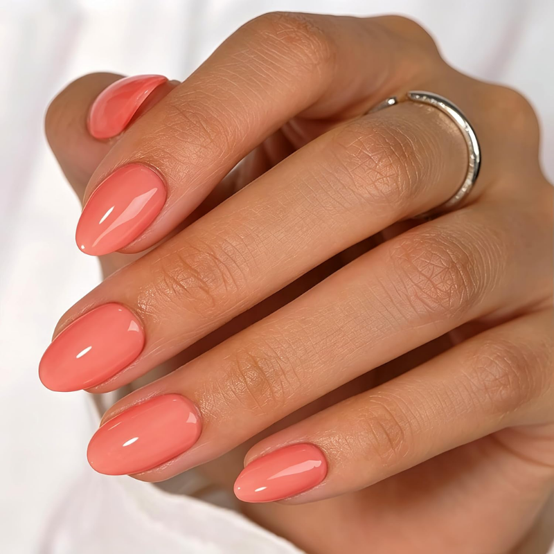 Coral nails that make your skin look more tan and enhance a sun-kissed glow.