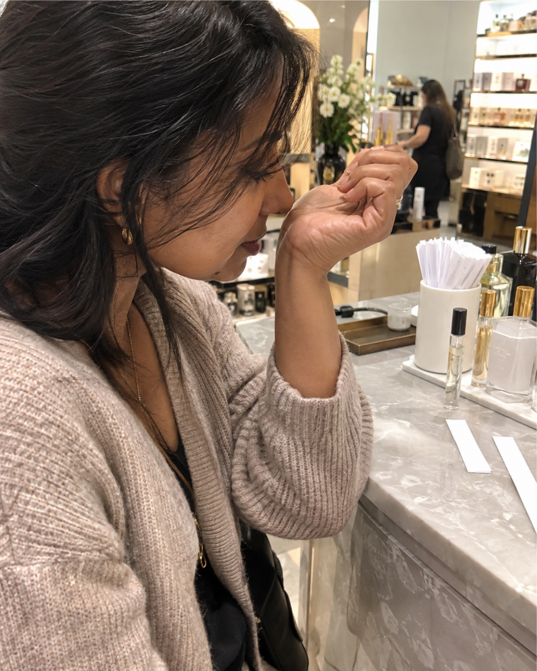 woman sampling perfume in a store