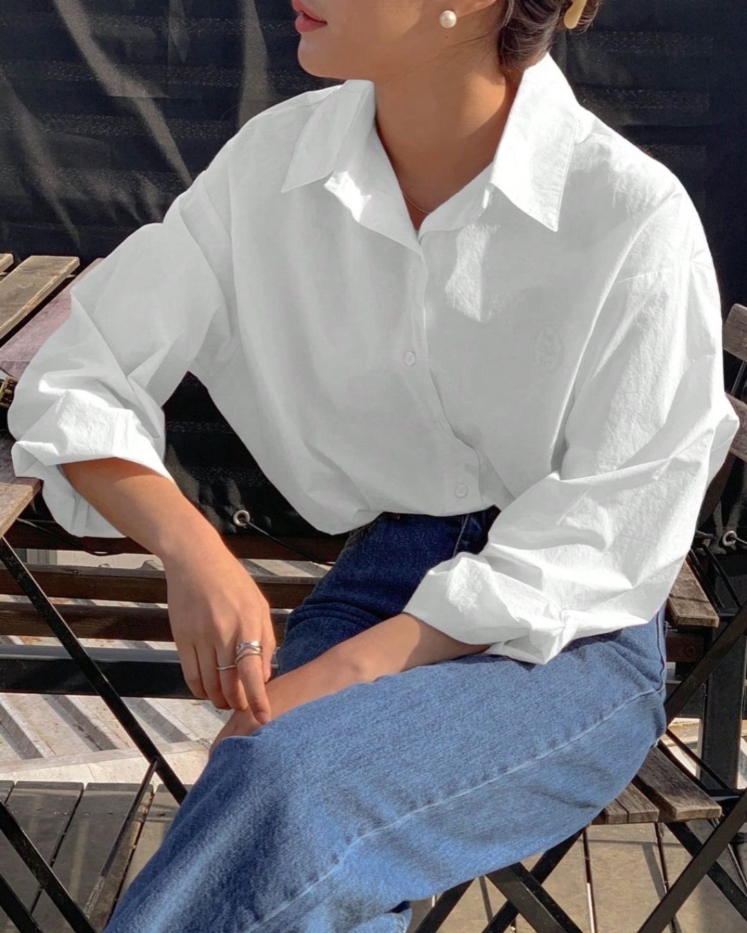 woman wearing a white button down shirt and jeans