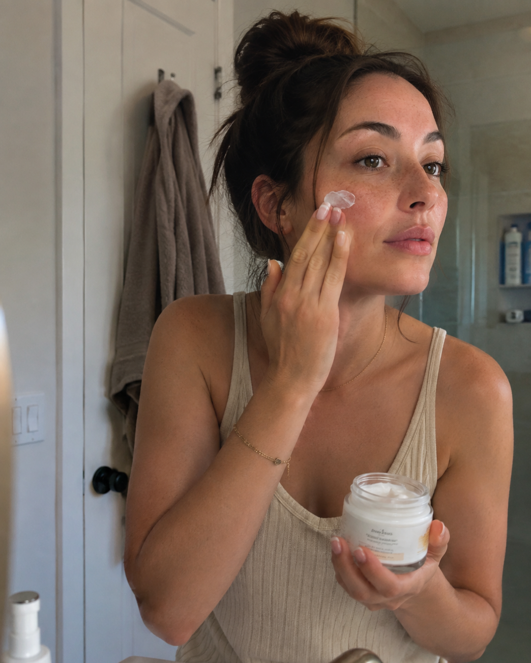Women doing viral TikTok trend of Skin Cycling in the mirror.