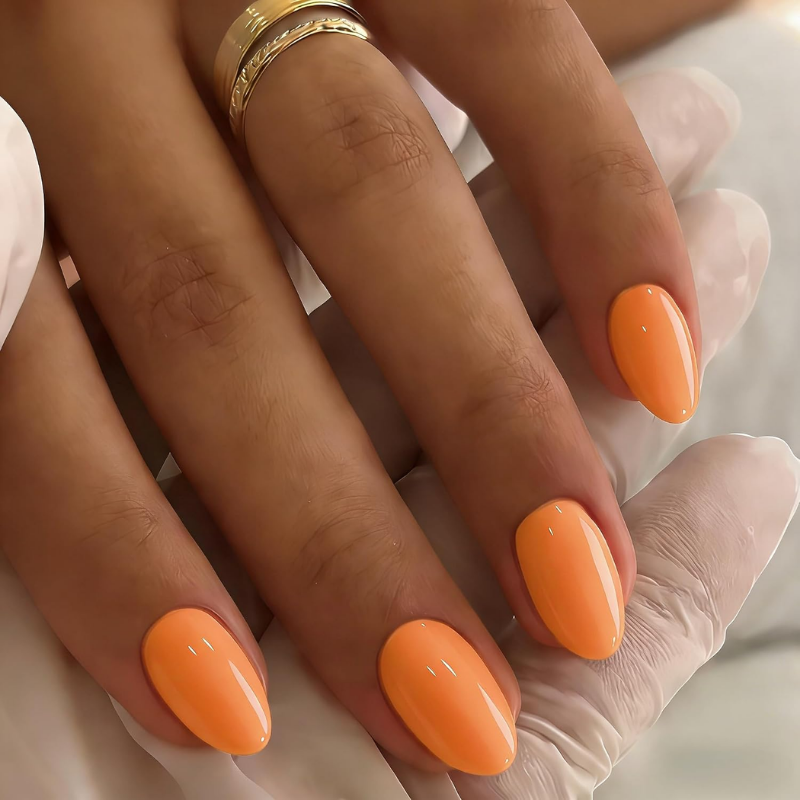 Bright orange nails that make your skin look more tan and enhance a sun-kissed glow.