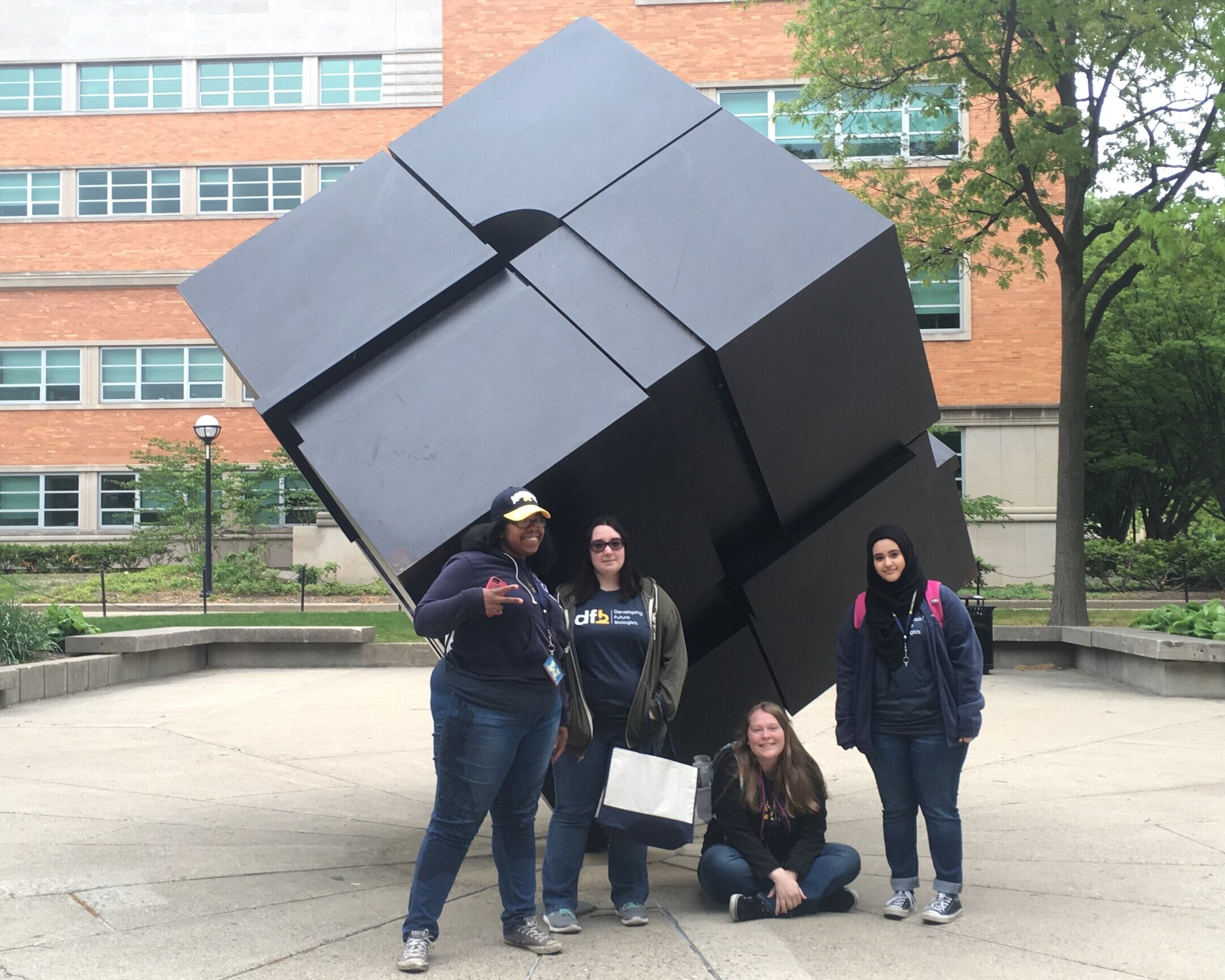  Students pose with The Cube at U-M’s Central Campus 