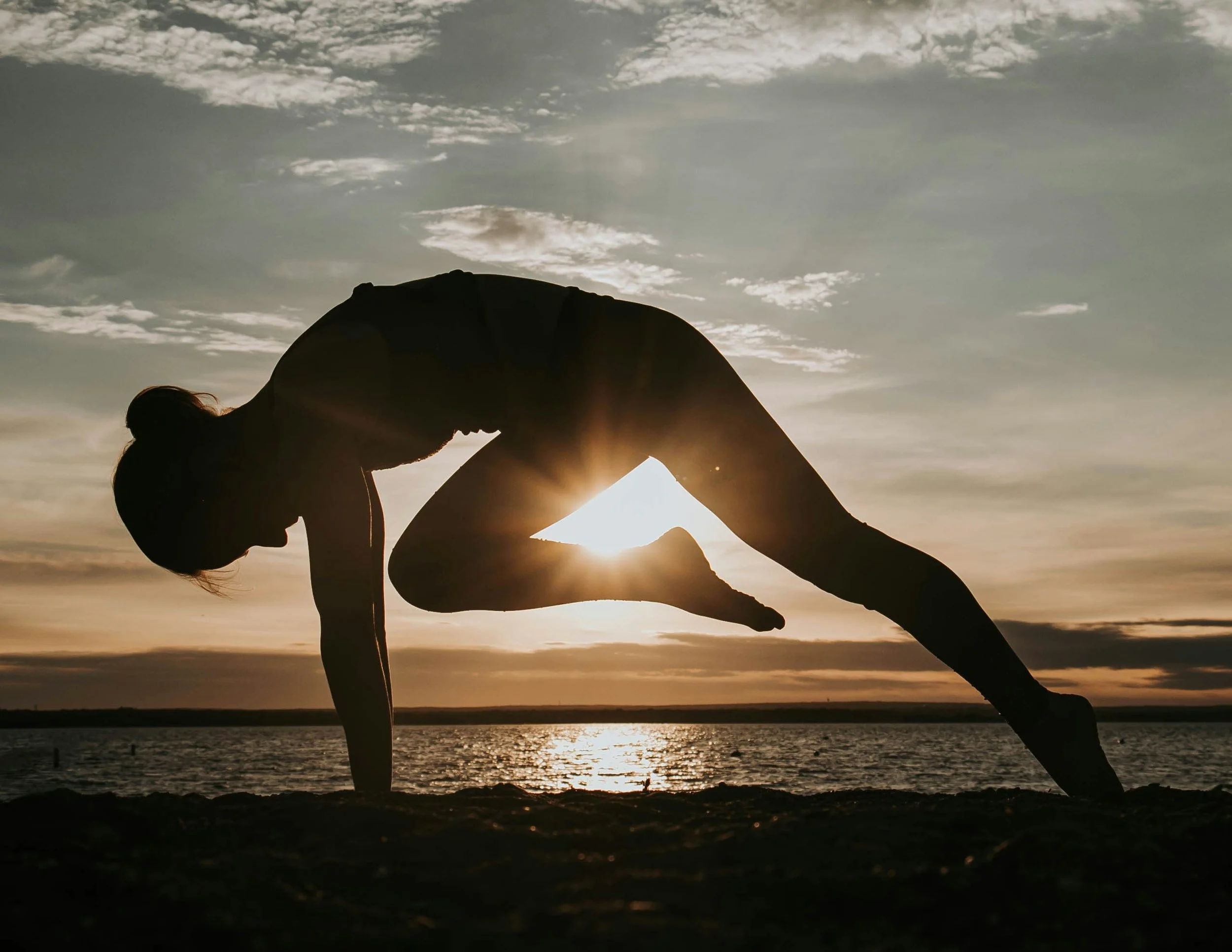 Woman doing Pilates on the beach