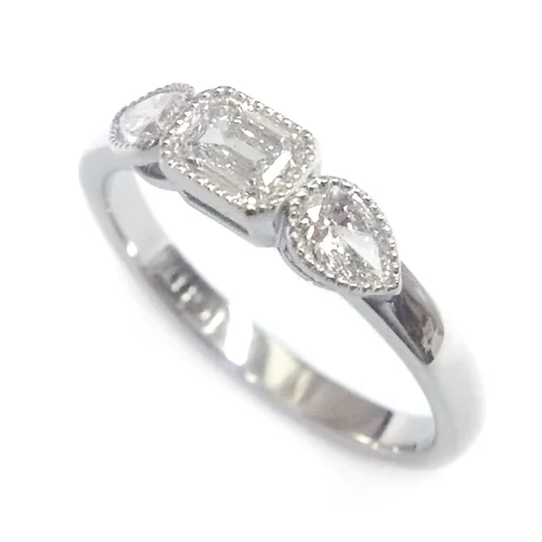 Platinum Emerald and Pear Cut Diamond Trilogy Engagement Ring.jpg