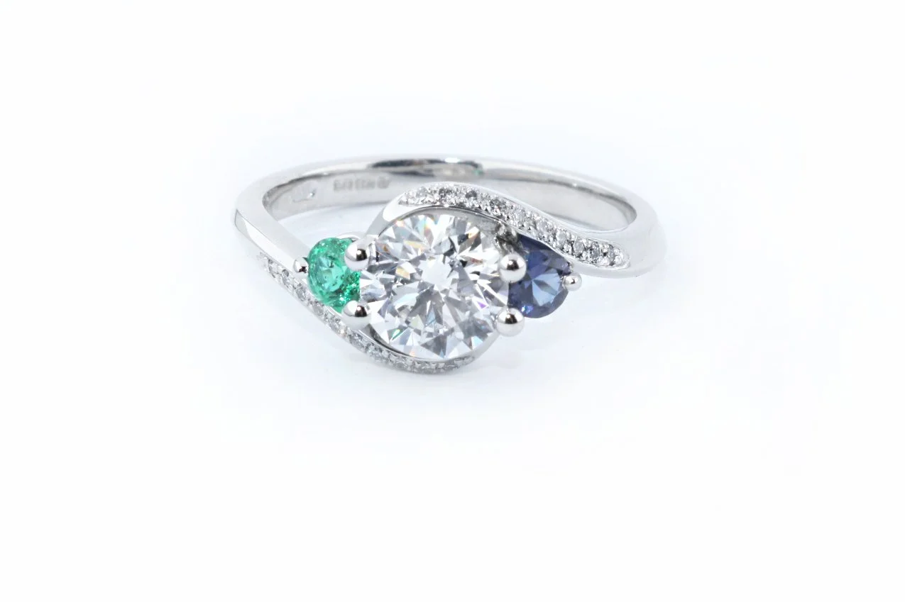 Platinum Diamond Crossover Dress Ring with Emerald and Sapphire