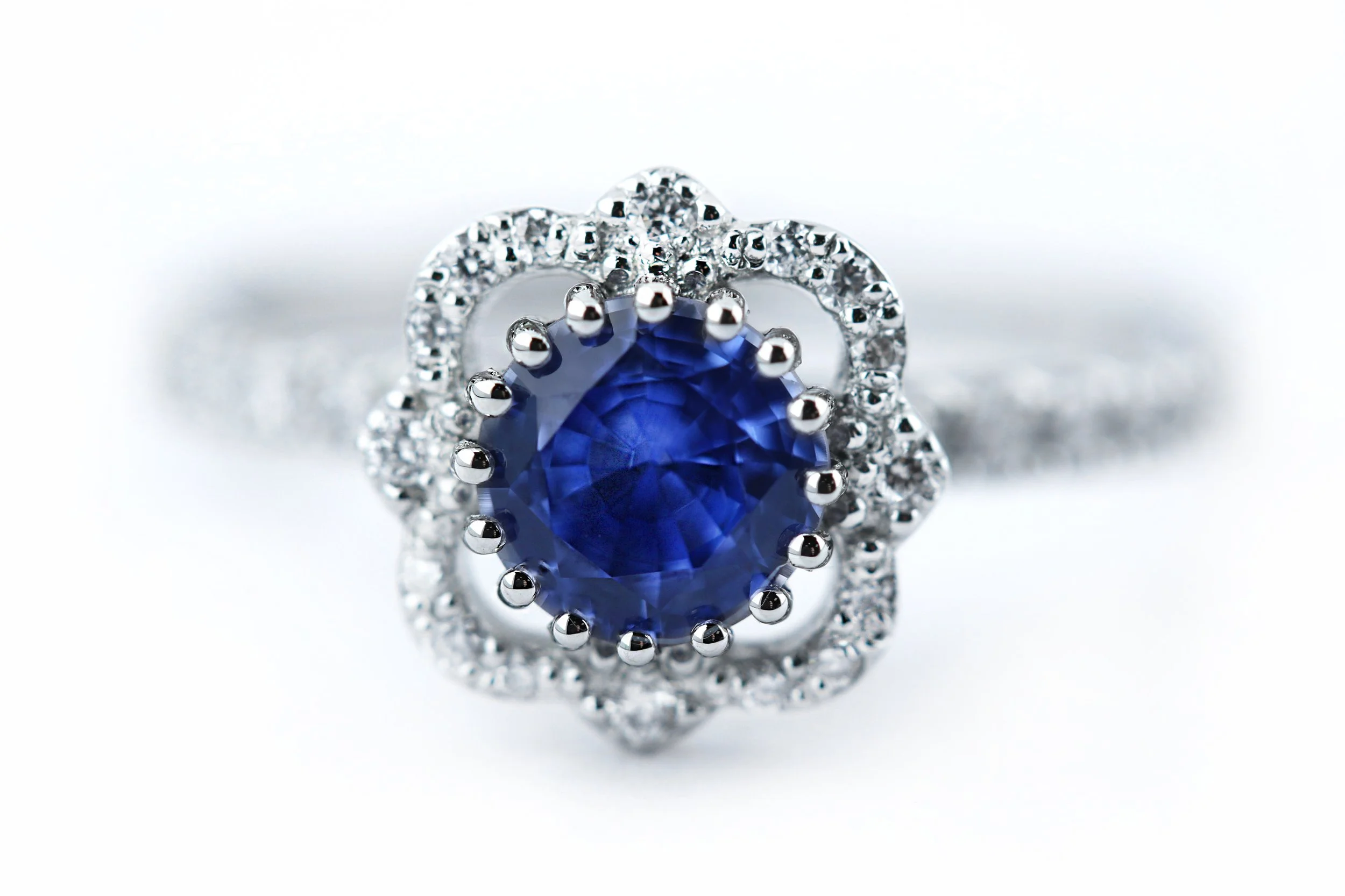Sapphire and Platinum Halo with Diamond Set Shoulders