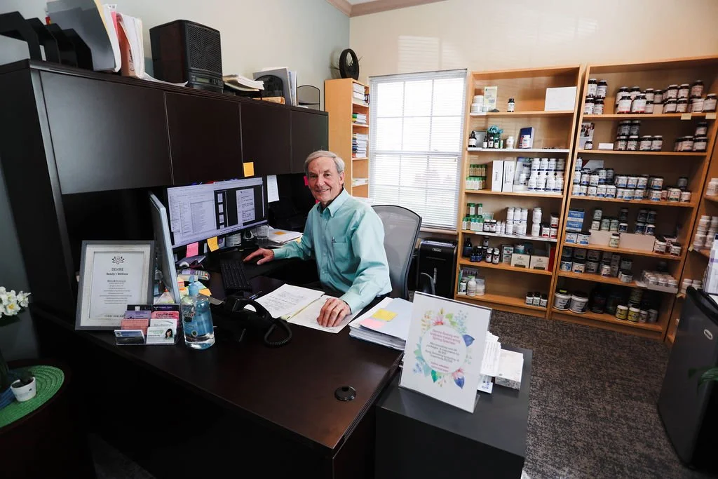Dave Evans, office manager, posing at his desk.