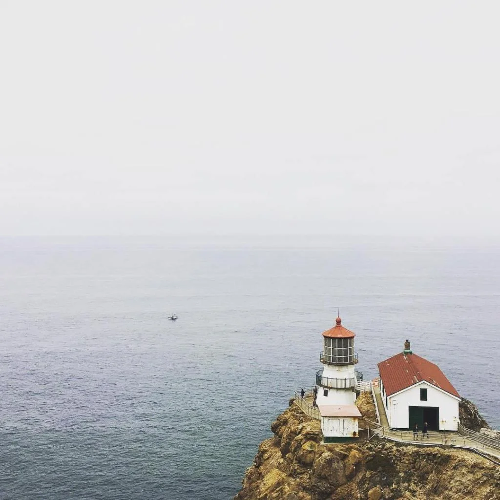A white lighthouse looking out over the sea