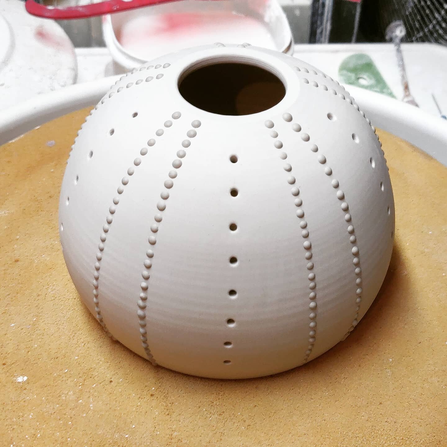 Progress on the pendant lamp from my last post:

Holes drilled and smoothed, slip dots applied...now to let it dry while I make other work and then into the kiln it goes!