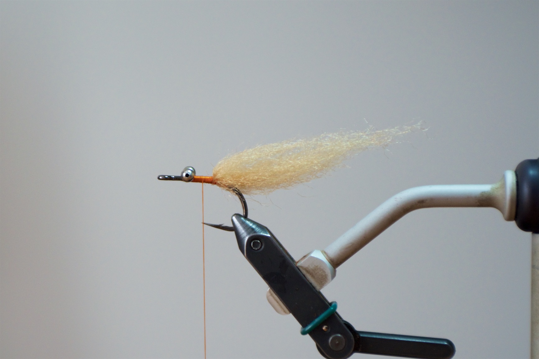 Step 3: Advance the thread to the midpoint between the point and the barb of the hook. Tie in another tapered strand of EP Fiber.