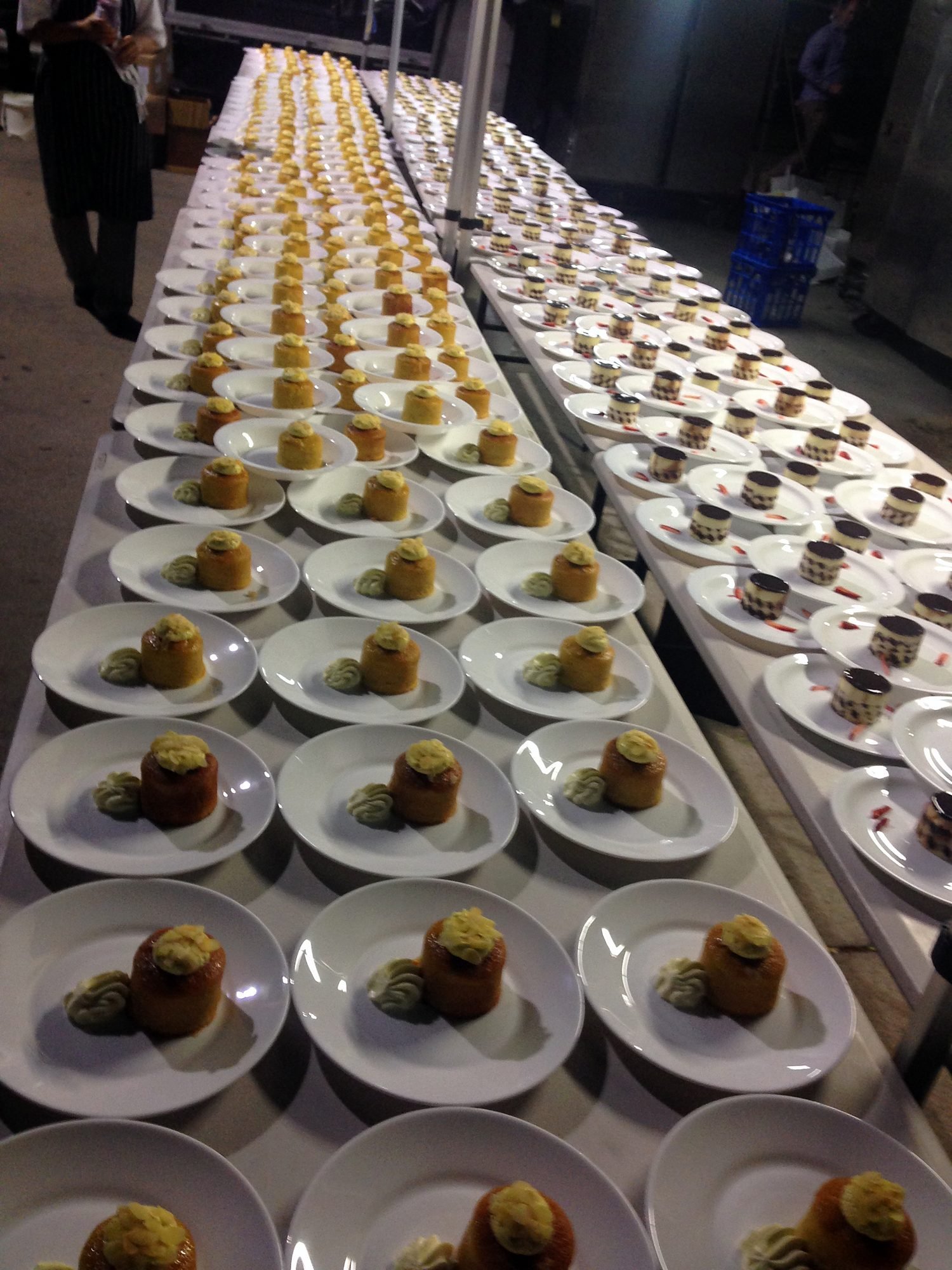 Long rows of plated entrees for a conference dinner