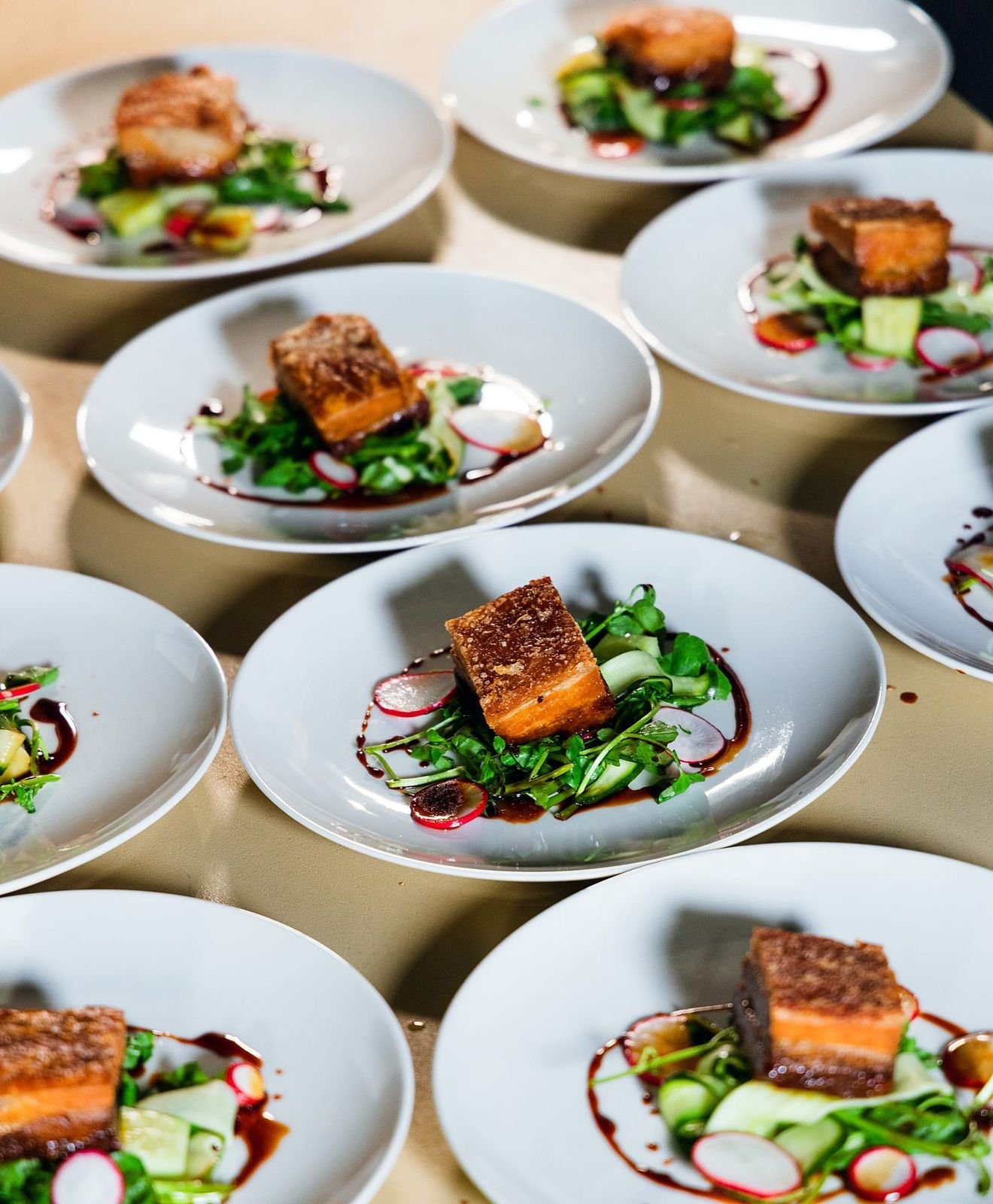 Plates of pork belly with fresh salad ready to serve