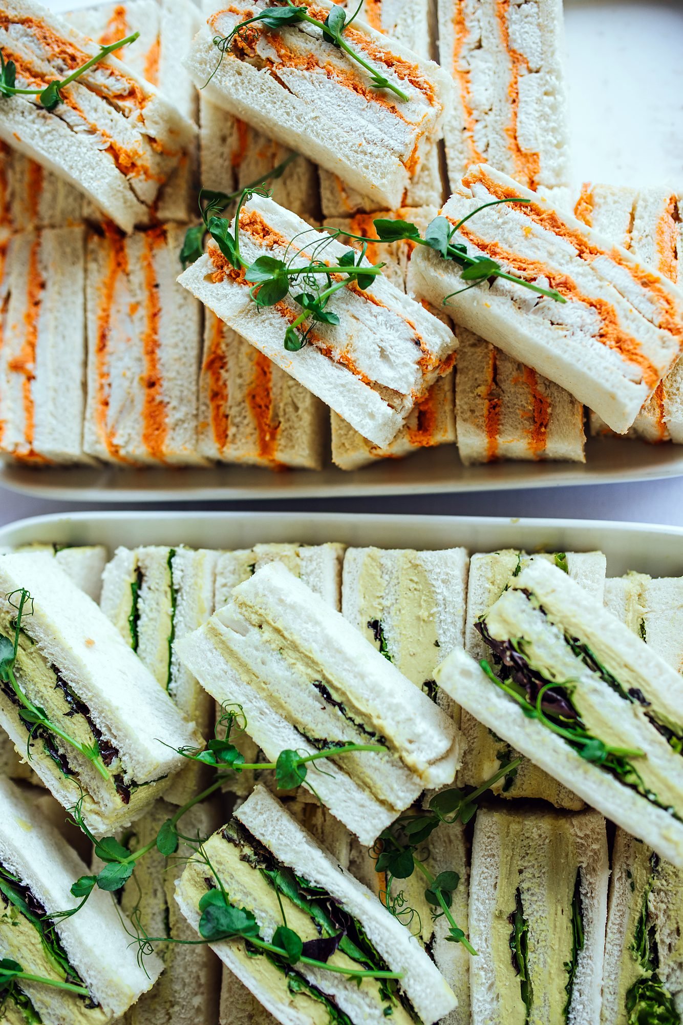 Platter of fresh ribbon sandwiches prepared for conference catering