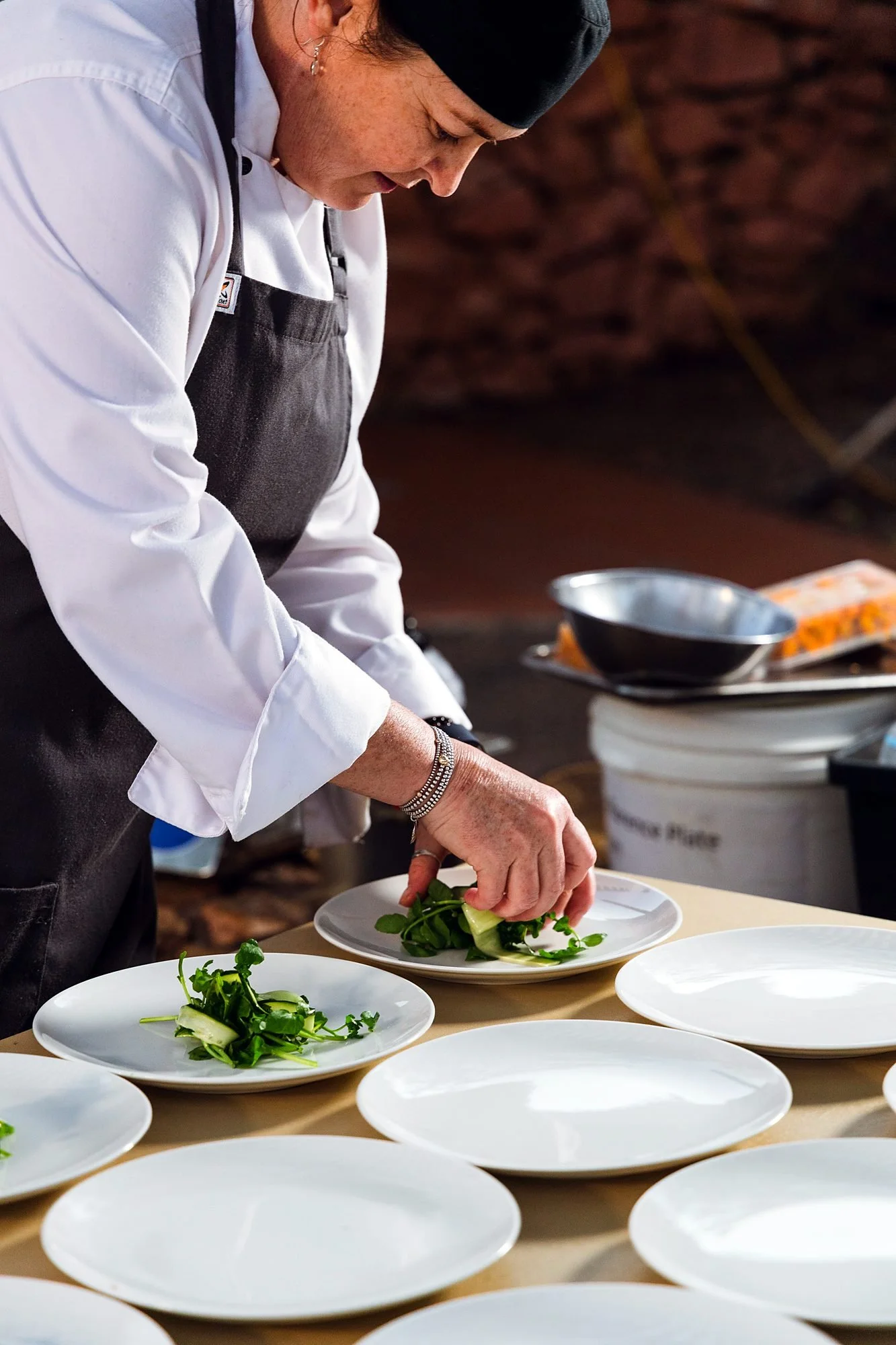 Michels chef plating wedding entrées in the kitchen