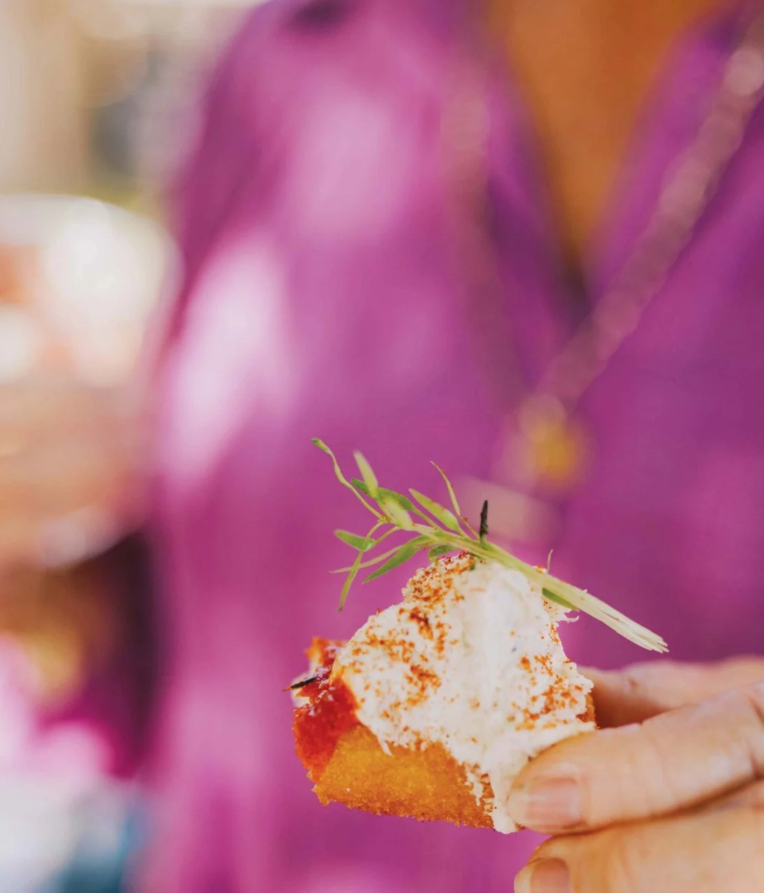 Guest holding a canape at a Michels cocktail event