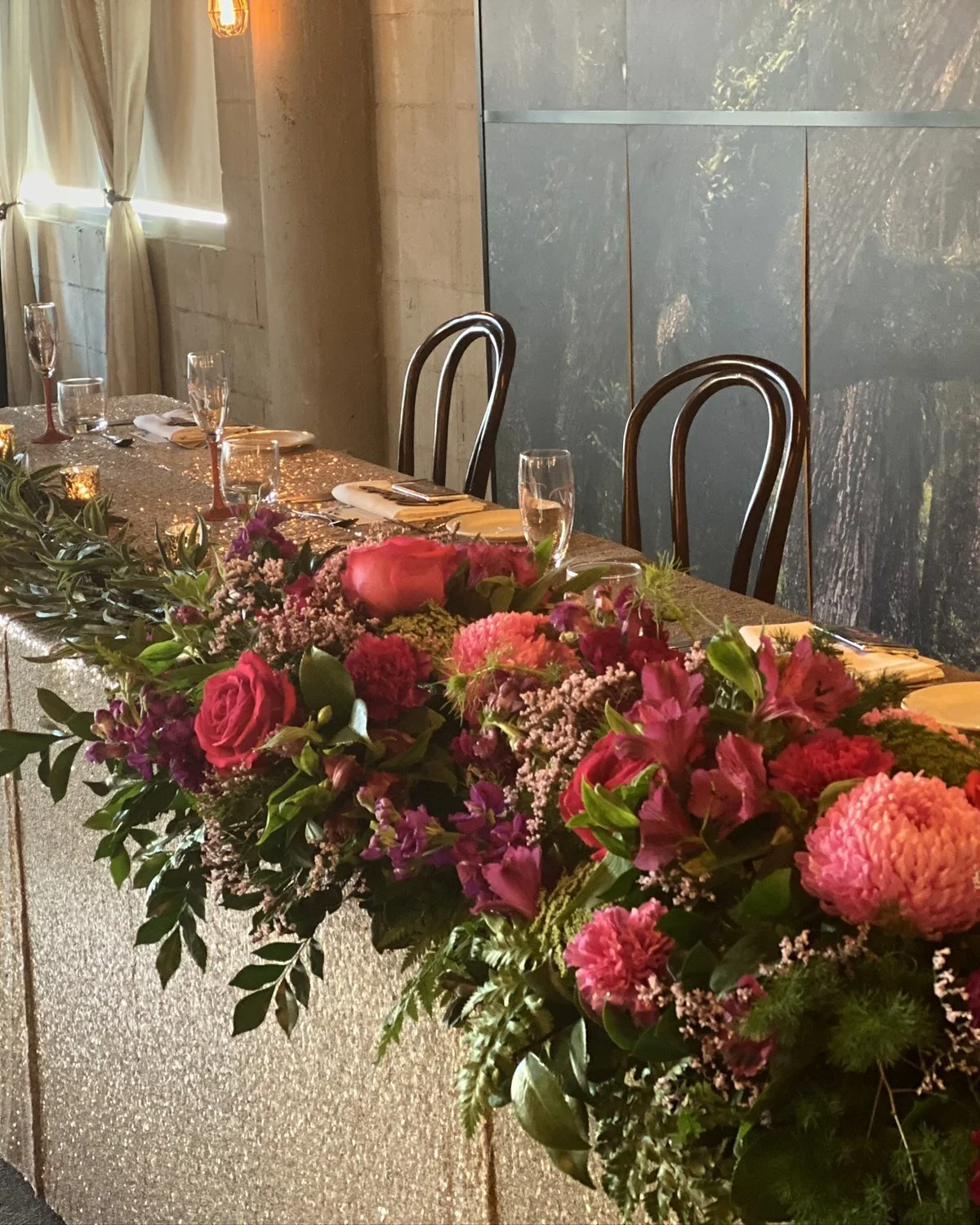 Bridal table dressed with pink and red florals