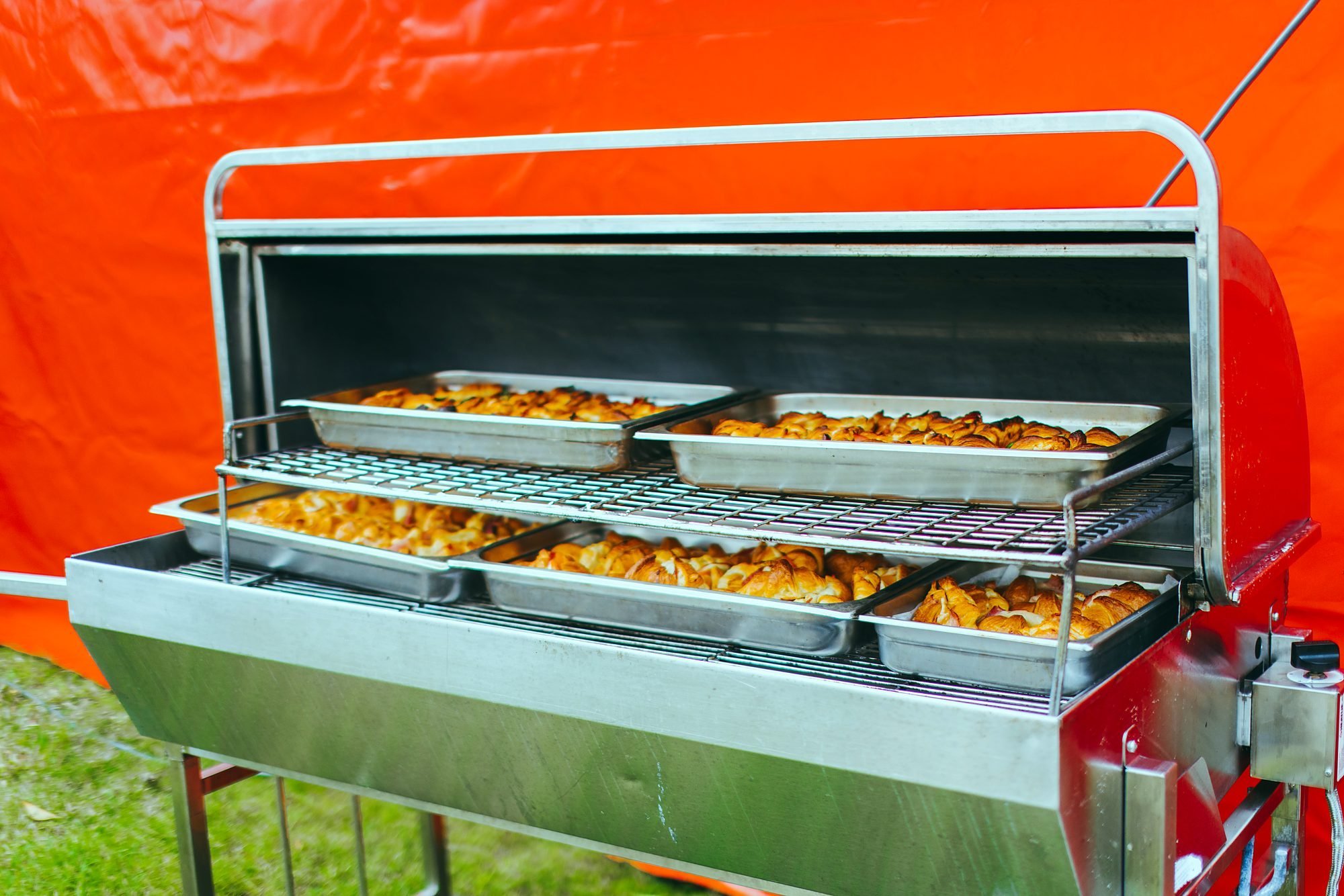 Mobile oven keeping trays of food hot on site
