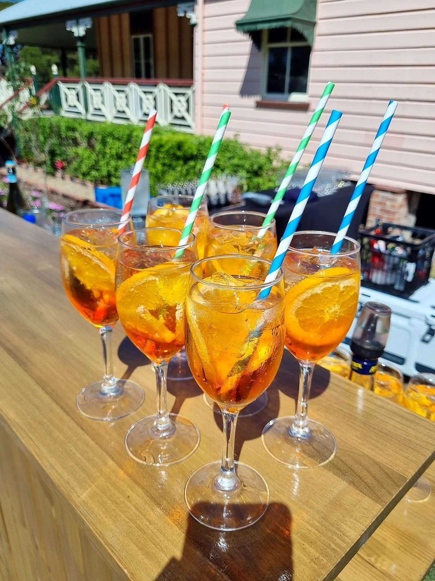 Spritz cocktails with orange slices lined up on the bar