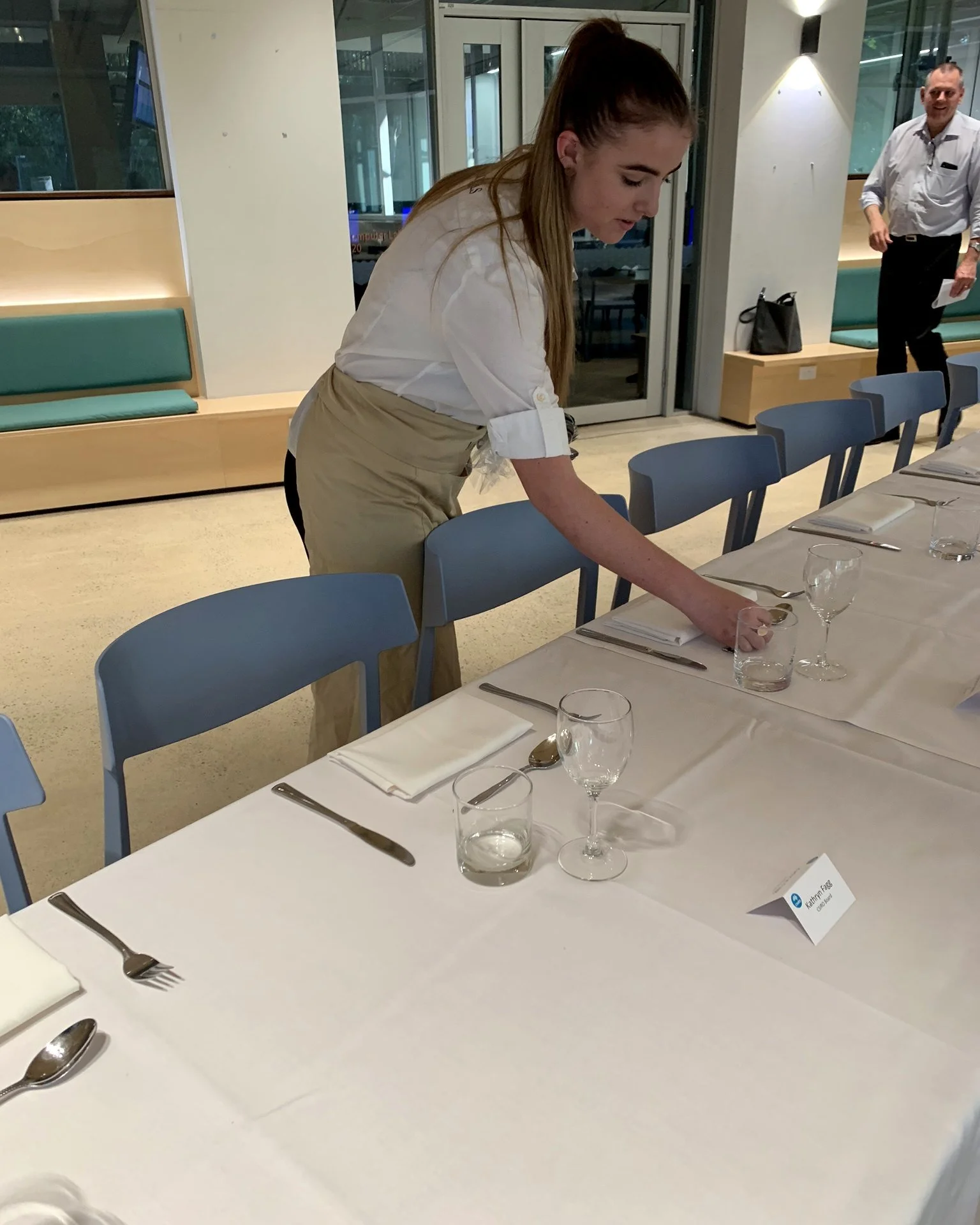 Michels staff setting a long table for a conference