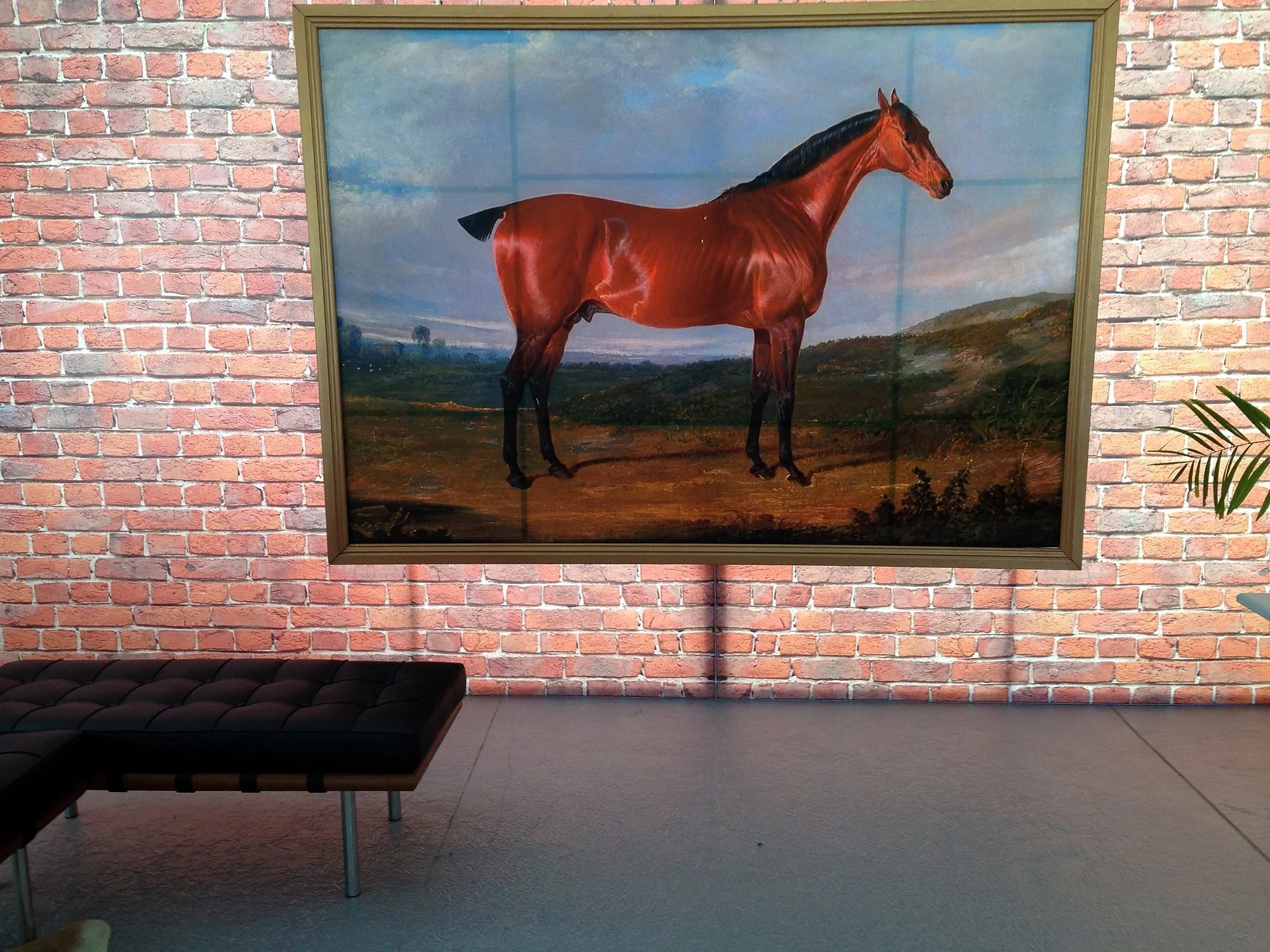 Function room with a large horse painting on an exposed brick wall