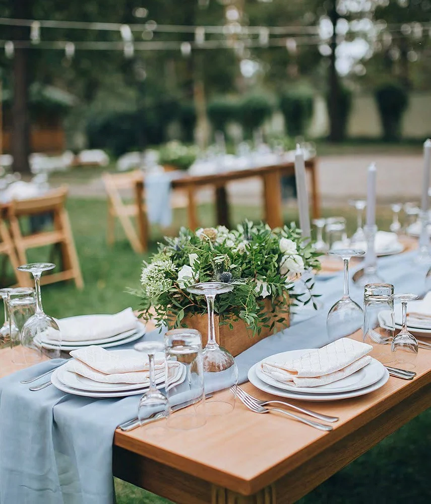 Outdoor wedding long table set with white florals and candles