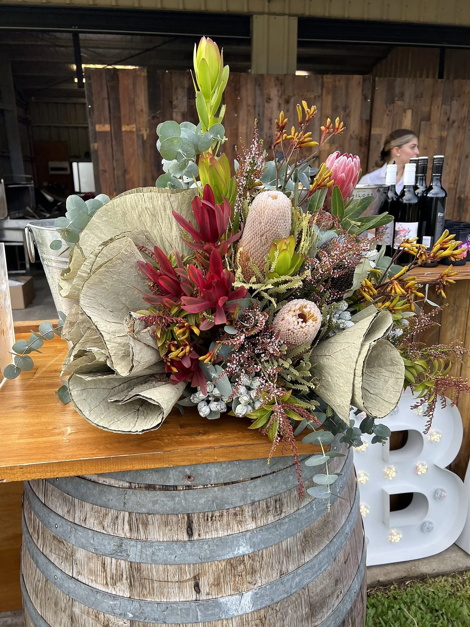 Native floral styling on a timber barrel