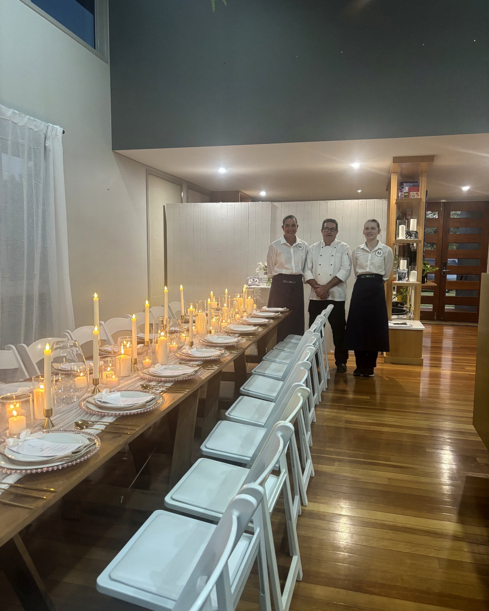 Candlelit wedding reception table with the Michels team ready