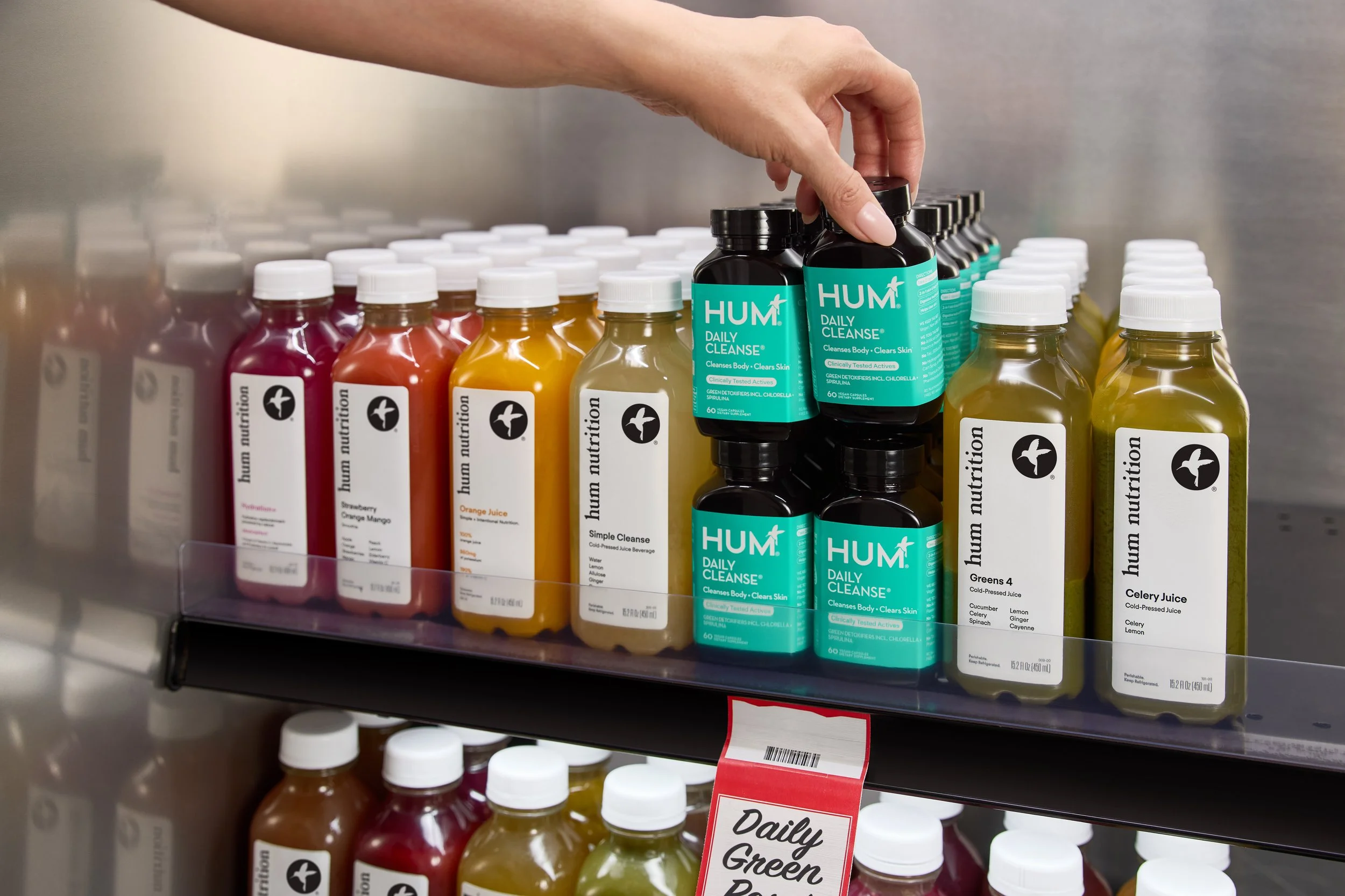 set designer DANA KAPUSTIN top Los Angeles prop stylist and art director juice bottles in a juice aisle featuring hum nutrition daily cleanse