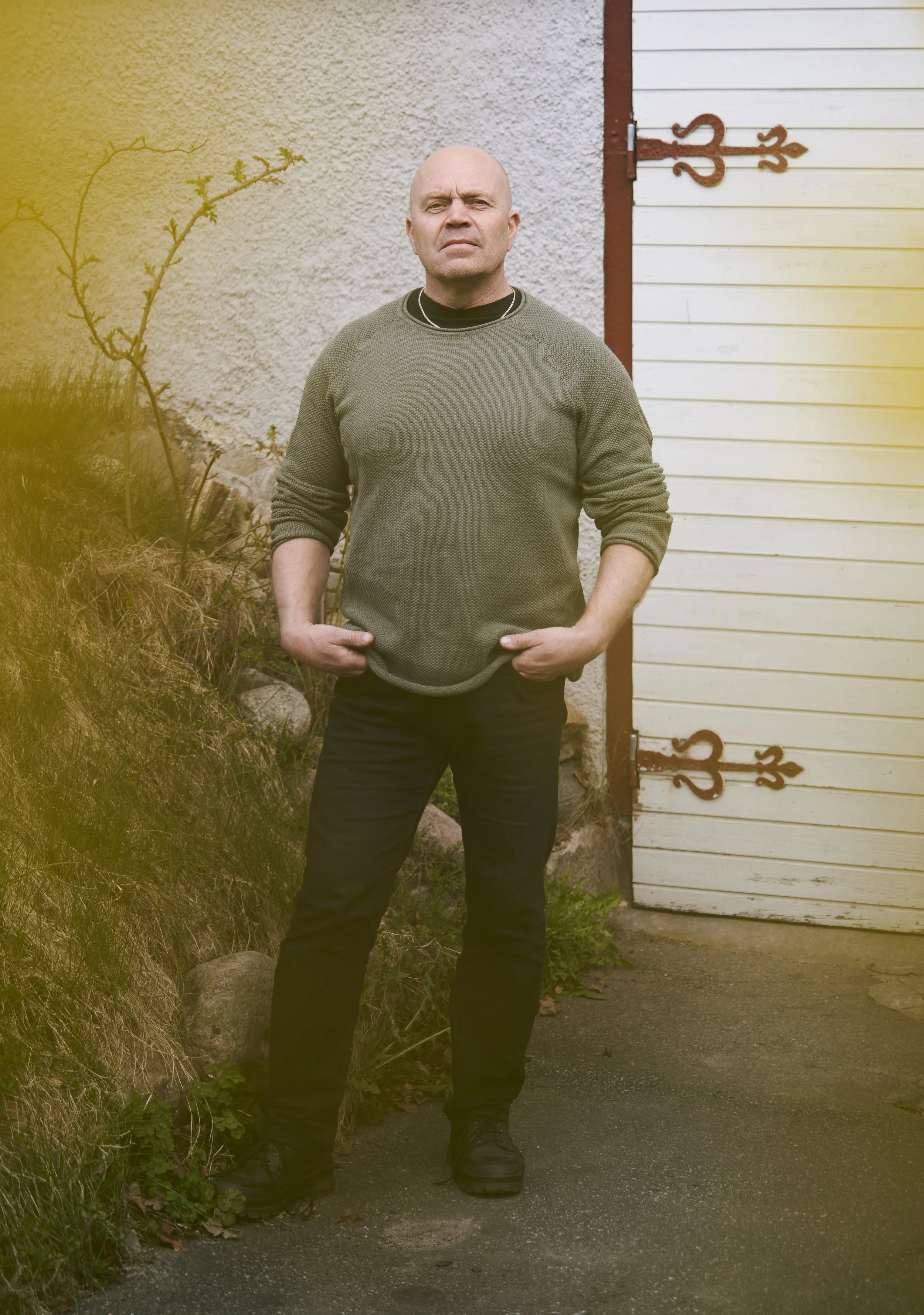 Porträtt av Magnus ståendes med händerna i fickorna.