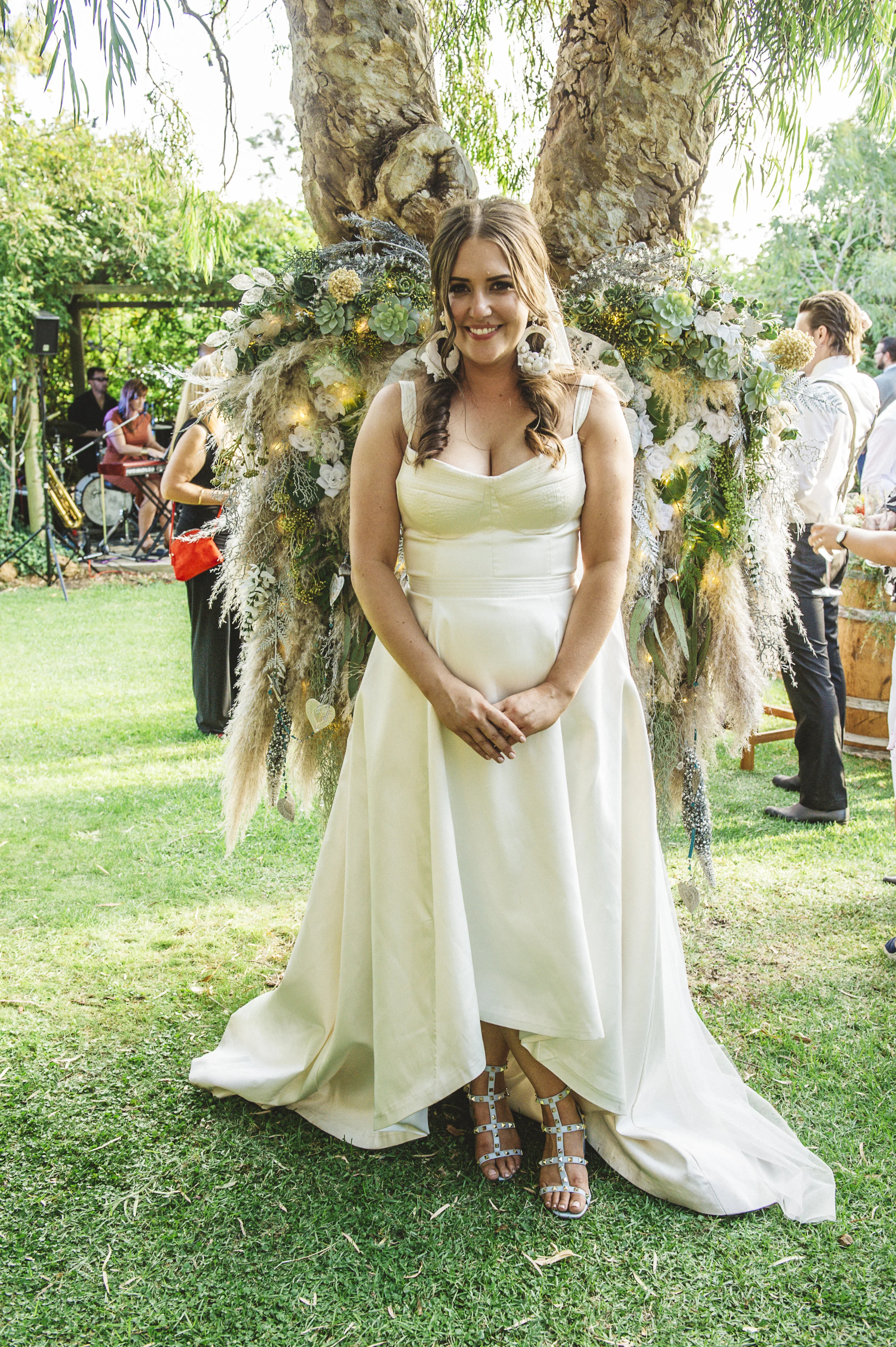beautiful bride posing for photo in white gown smiling
