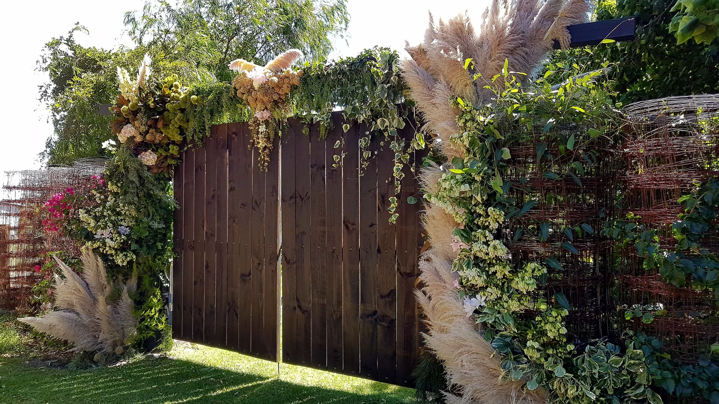beautiful wedding flowers on a wooden gate into the garden