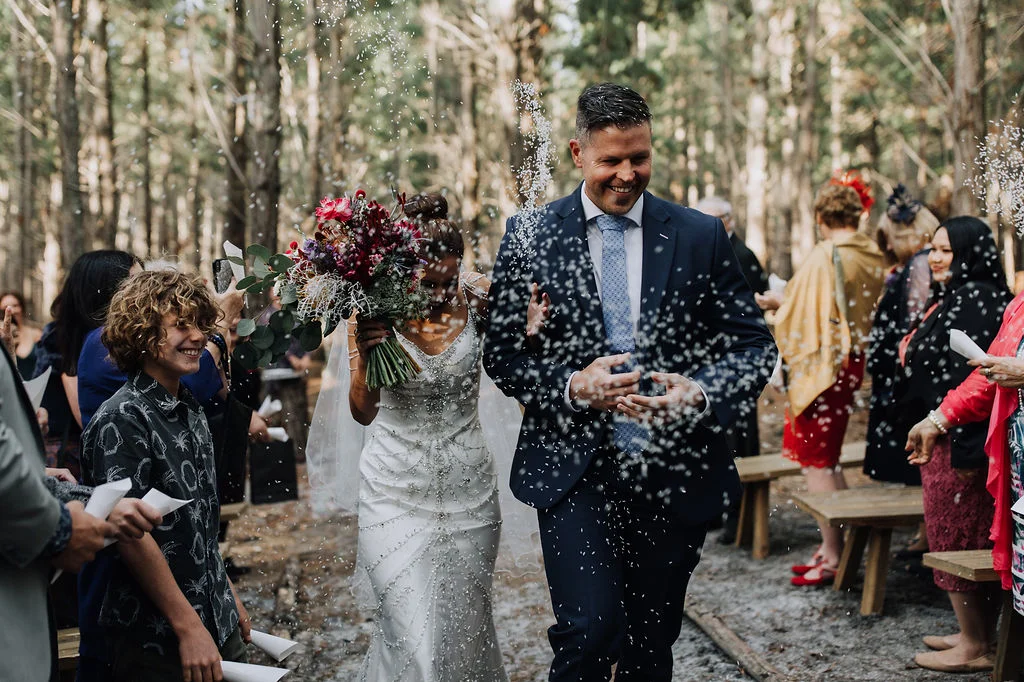 beautiful couple walking down the aisle with guest happy
