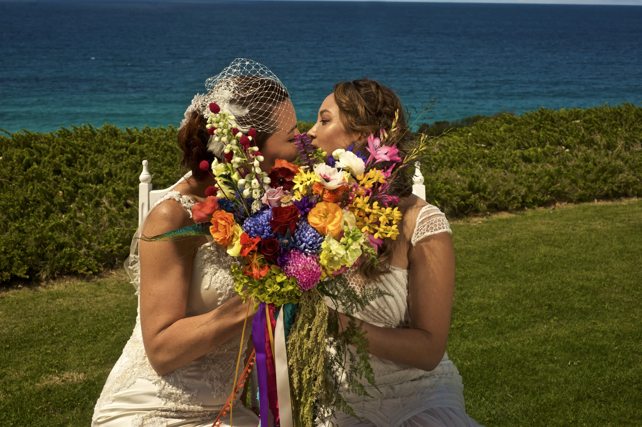 beautiful couple wedding kissing holding flowers