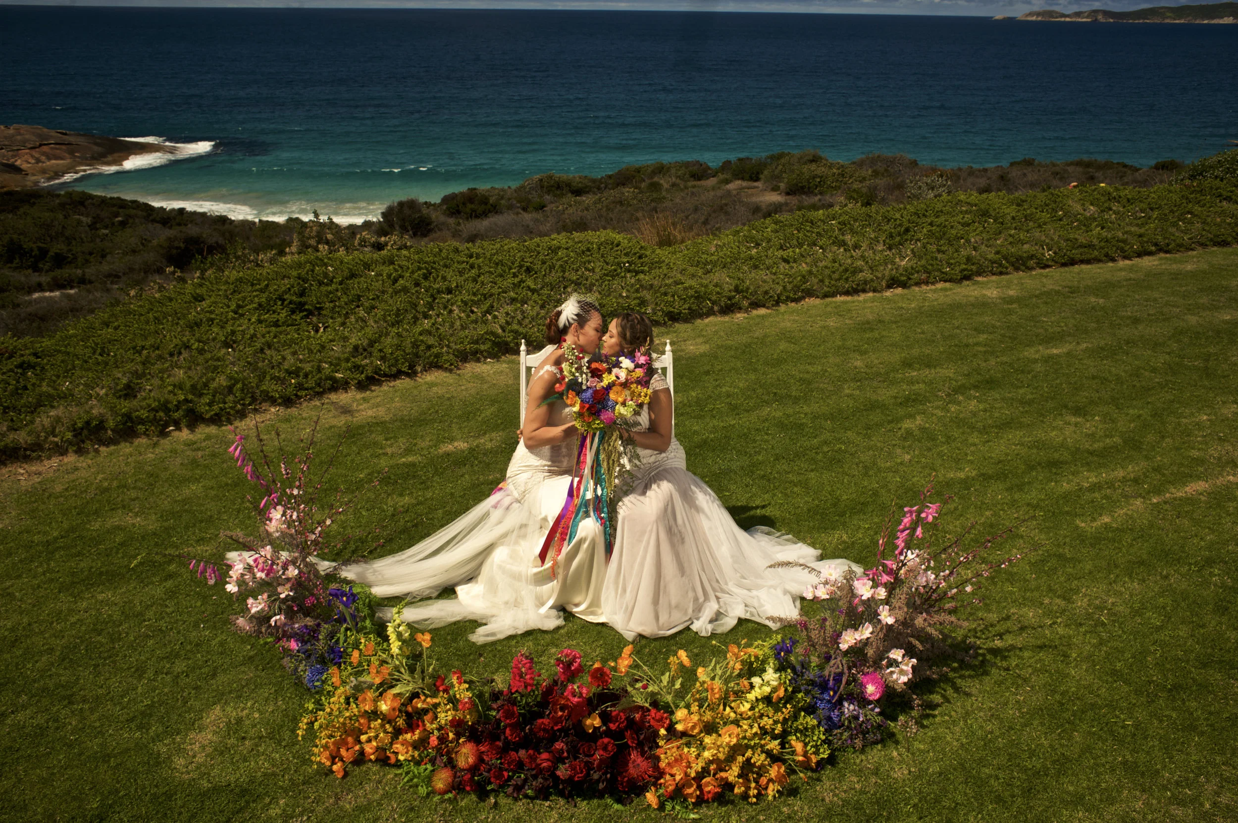 beautiful couple kissing surrounded by flowers bouqet